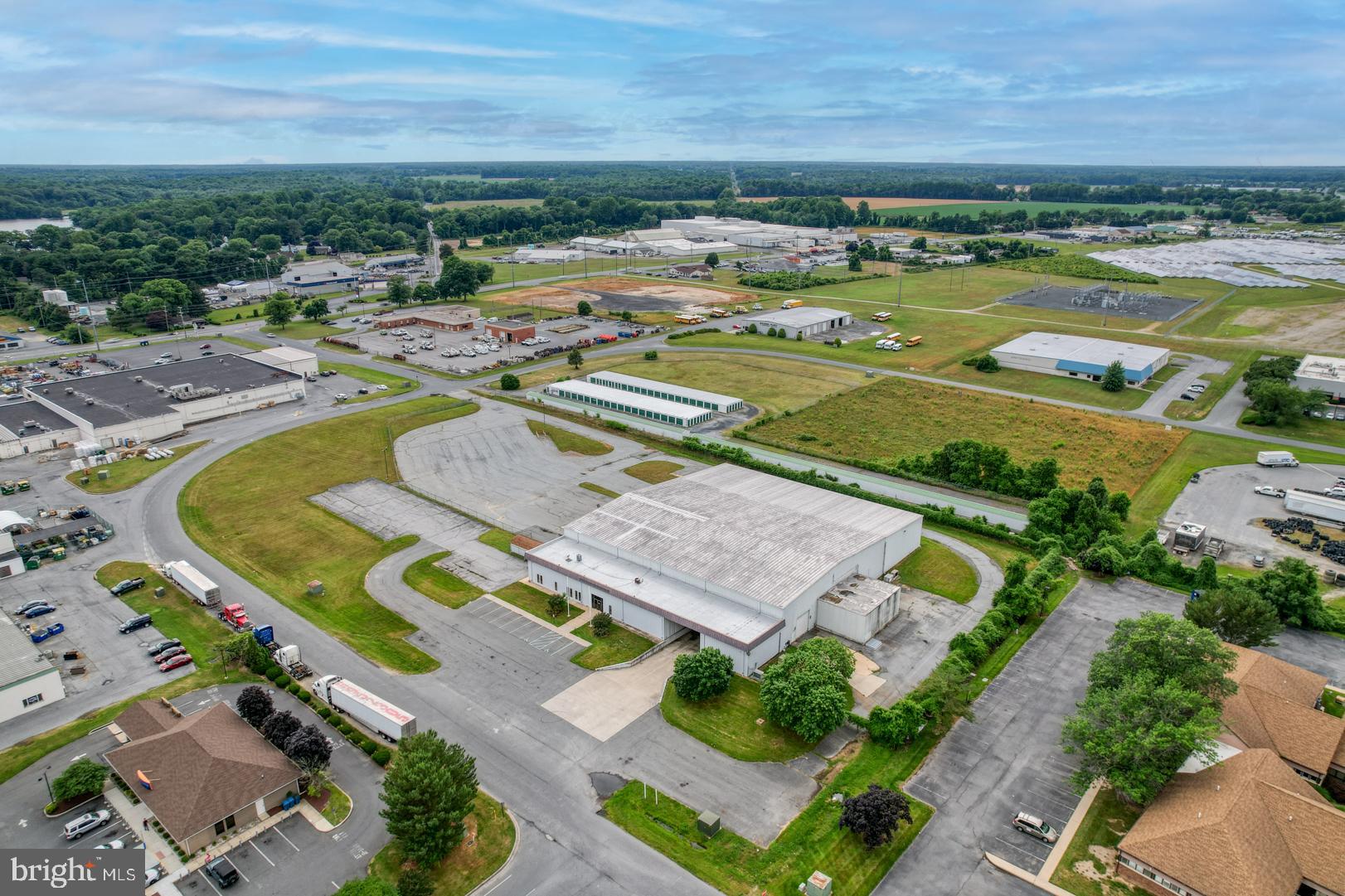 Industrial Warehouse and office space in Prime location for distribution.  Primary parcel with building is 2.83 acres and a second parcel of 2.6 acres included offers ability for expansion.   The building was originally designed as a beer distribution center with finished office space,  walk-in refrigeration units, three 20'-26' clear span warehouse bays.  Bay 1 is a drive through bay for pick up and delivery with a separate covered loading dock.    Bay 2 is insulated with HVAC units to control temperature for product storage.  Bay 3 is clear span with 3 loading ramps/docks.  The roof has 10 yrs left on its warranty.  A total of 5.43 acres and over 38,000 sq ft of building when including warehouse, office and refrigeration.