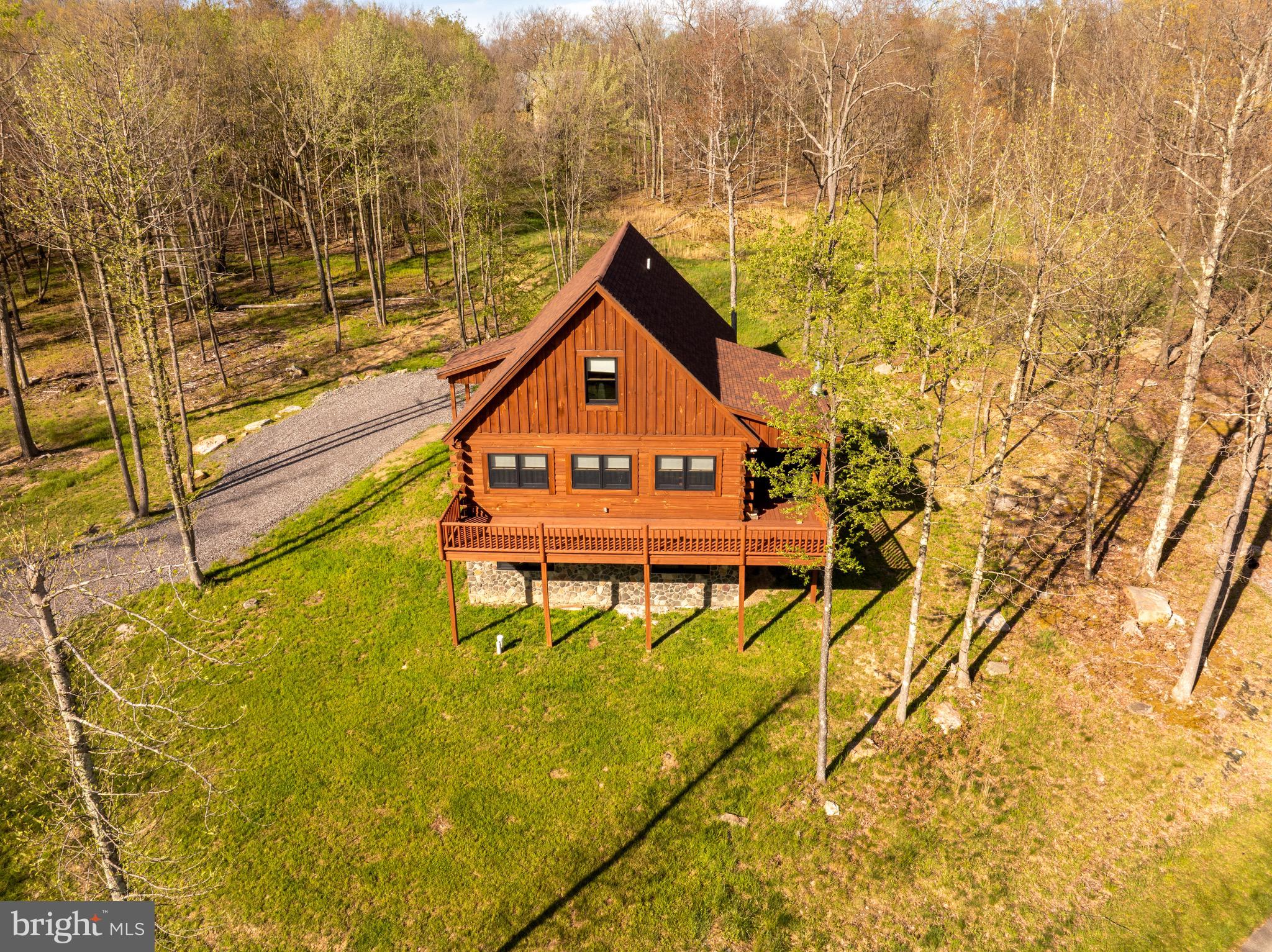 Rare Deep Creek-area two (2) lot offering! 50 Blue Mountain View is being offered with adjoining Lot 34 Blue Mountain View, creating approx. 1.22 total acres in McHenry's Lodestone/Biltmore area. Currently operating as the vacation rental "John's Place" this mountain-view 4BR, 3 full/1 half bath retreat sleeps 10 and is ready for continued rental use or personal enjoyment. Built in 2022, the single-family home offers approx. 1,708 sq ft on a 0.58-acre homesite near Deep Creek Lake, Wisp Resort, Funland, skiing, hiking, dining, and year-round attractions. The unfinished basement provides excellent opportunity for future expansion, with room to create a game room, bonus living area, or potential additional bedroom space, subject to applicable requirements. The included 0.64-acre adjoining Lot 34 adds valuable elbow room, privacy, and future possibilities. Buyer to verify rental permits/regulations, occupancy, HOA requirements, utilities, acreage, and Lot 34 buildability/permitted uses.