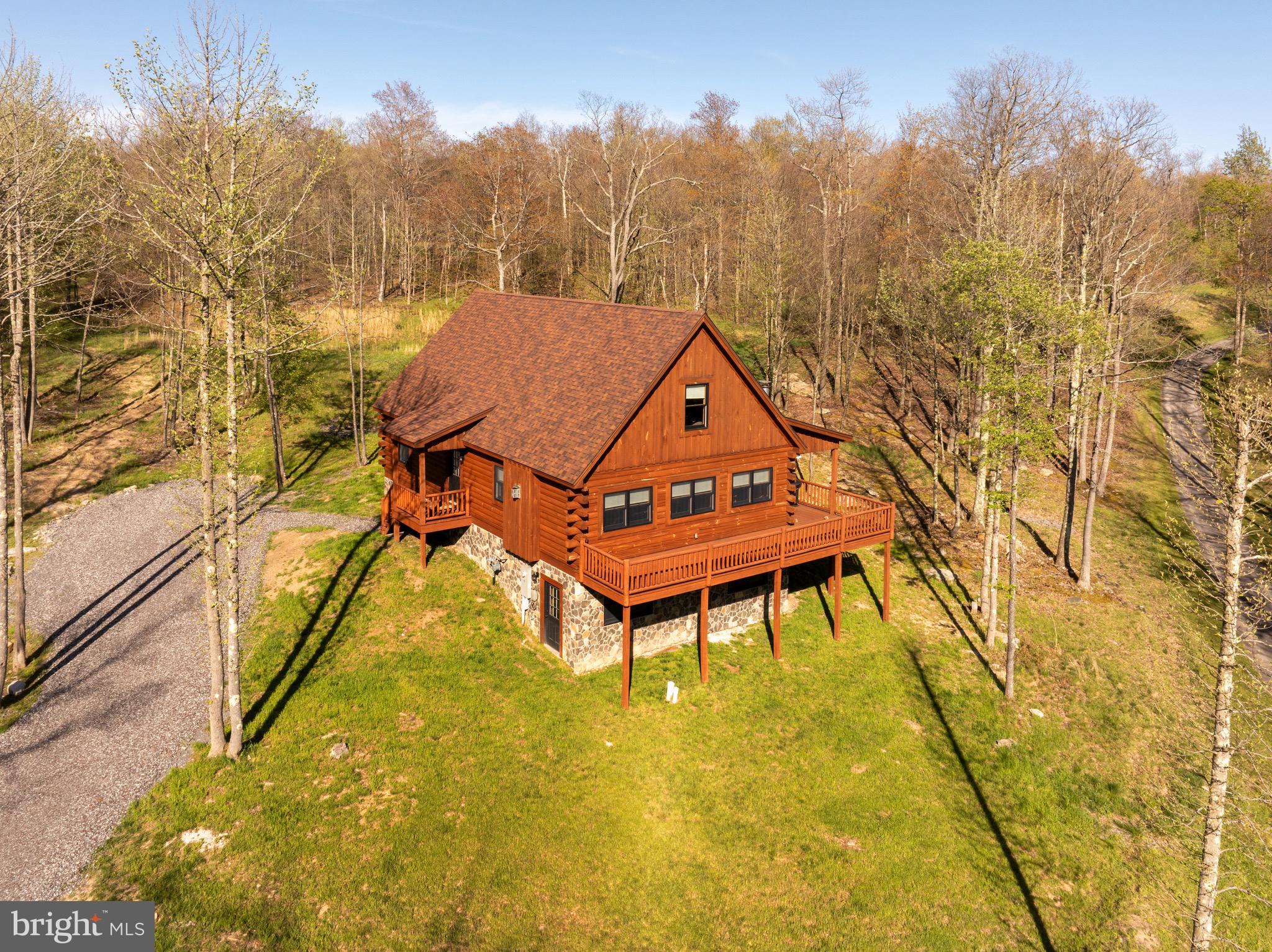 Rare Deep Creek-area two-parcel offering! 50 Blue Mountain View is being offered with adjoining Lot 34 Blue Mountain View, creating approx. 1.22 total acres in McHenry's Lodestone/Biltmore area. Currently operating as the vacation rental "John's Place" this mountain-view 4BR, 3 full/1 half bath retreat sleeps 10 and is ready for continued rental use or personal enjoyment. Built in 2022, the single-family home offers approx. 1,708 sq ft on a 0.58-acre homesite near Deep Creek Lake, Wisp Resort, Funland, skiing, hiking, dining, and year-round attractions. The unfinished basement provides excellent opportunity for future expansion, with room to create a game room, bonus living area, or potential additional bedroom space, subject to applicable requirements. The included 0.64-acre adjoining Lot 34 adds valuable elbow room, privacy, and future possibilities. Buyer to verify rental permits/regulations, occupancy, HOA requirements, utilities, acreage, and Lot 34 buildability/permitted uses.