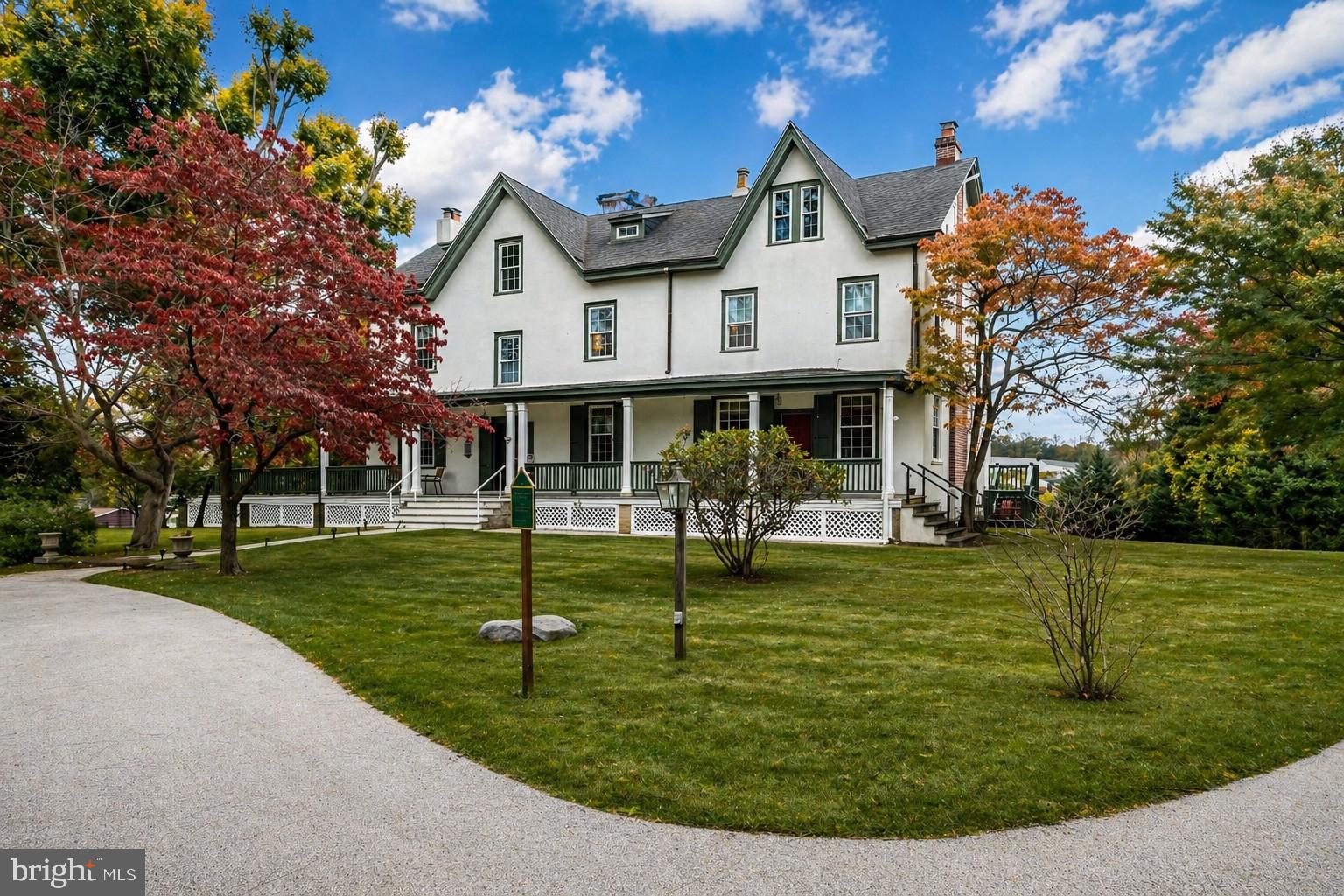 A rare historic estate in Newtown Square, The Edgar House offers nearly 6,000 square feet of livable space on more than 1.3 private, lushly landscaped acres in one of Delaware County’s most established and sought-after locations. Originally built in 1840 and thoughtfully expanded in 1910 and 2008, this Federal-style landmark blends timeless American architecture, estate-scale privacy, and exceptional flexibility for
today’s luxury buyer. Set quietly off the road, the home immediately conveys a sense of permanence and character rarely found in modern construction. Thick stone walls, real hardwood floors, detailed crown moldings, multiple fireplaces, and classic architectural proportions speak to the craftsmanship of another era, while the home’s expansive layout provides the scale and versatility today’s buyers demand. Spanning three full stories plus a finished basement, the residence offers 6 bedrooms, 8 bathrooms, and an intelligent floor plan suited for multigenerational living, entertaining, working from home, or creating a private compound-style retreat. The great room layout opens the home for everyday living and gatherings, while two ensuite primary bedrooms provide comfort, privacy, and flexibility. Historic details are found throughout, including front and rear staircases, rich millwork, and a rare interior smoke room that nods to the property’s storied past. Practical updates, including an updated shingle roof and a Viking gas appliance package in the kitchen, help balance the home’s old-world substance with modern livability. Outside, a
1,600-plus square foot wraparound deck and patio overlook mature landscaping, creating a private outdoor setting designed for entertaining, relaxing, and enjoying the acreage. A circular driveway enhances the estate-like arrival, while the detached three-car climate- controlled garage adds both presence and function. A separate office space further expands the property’s utility, opening the door for a home-based business, studio, creative workspace, or private professional use. The property also offers meaningful future
upside, with room to expand the existing residence or potentially add a secondary structure, subject to applicable approvals. The Edgar House is more than a home. It is a local landmark with architectural significance, real substance, and long-term equity potential. For the buyer seeking privacy, scale, historic character, and opportunity in the heart of Newtown Square, this is a singular chance to own, personalize, and steward one of Delaware County’s most distinctive estate properties.