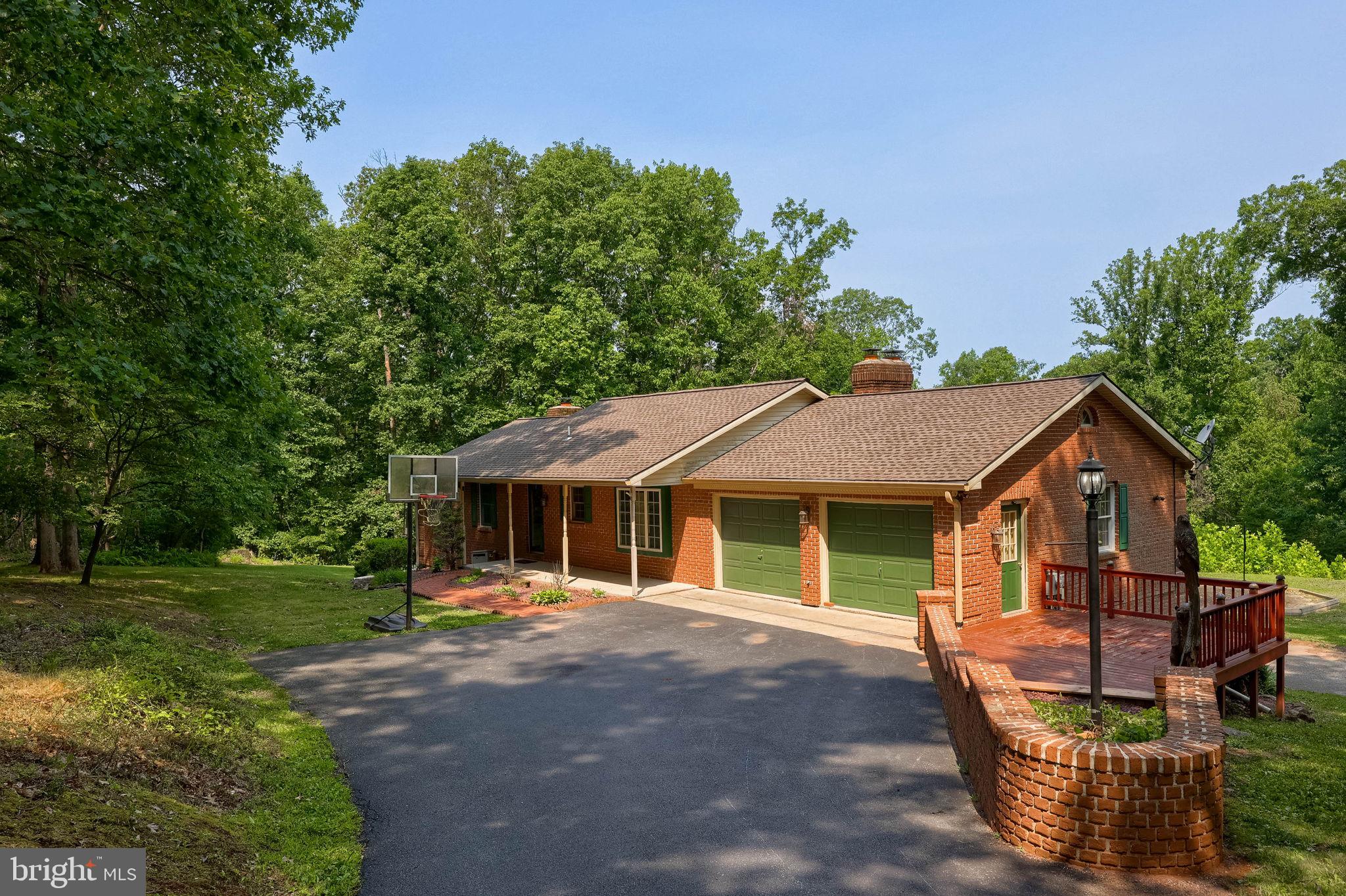 Welcome to your own 5+ acre private retreat, perfectly blending rural tranquility with commuter convenience! Situated just minutes off I-83, this all-brick rancher offers the ultimate one-floor living experience, making it an absolute dream for those commuting to either York or Harrisburg. From the moment you arrive, you will love the private, peaceful setting and the incredible panoramic views. Step inside to find a welcoming layout featuring a lovely eat-in kitchen with stainless steel appliances, solid surface counters and tile backsplash. The heart of the home is the sunken family room, highlighted by a dramatic floor-to-ceiling stone fireplace. From here, slide open the doors to a peaceful 21x16 screened-in deck—the perfect spot to sip your morning coffee or unwind while overlooking your private, level yard and those breathtaking views.
The main level plays host to 3 comfortable bedrooms and 2 full baths, while the finished walk-out basement massively expands your living space. This lower level features a spacious recreation room anchored by a cozy pellet stove, a private fourth bedroom, and a third full bath, making it an ideal setup for guests, teens, or an in-law suite.
For the hobbyist, mechanic, or car enthusiast, this property is a rare crown jewel. Along with the two attached 2 car garages (one of which is heated), you will find a separate 27x31 detached garage fully equipped with electricity, heat, space to park additional vehicles or toys, and a second-floor loft for all your storage needs. Ready to see this great home for yourself? Schedule your tour today!