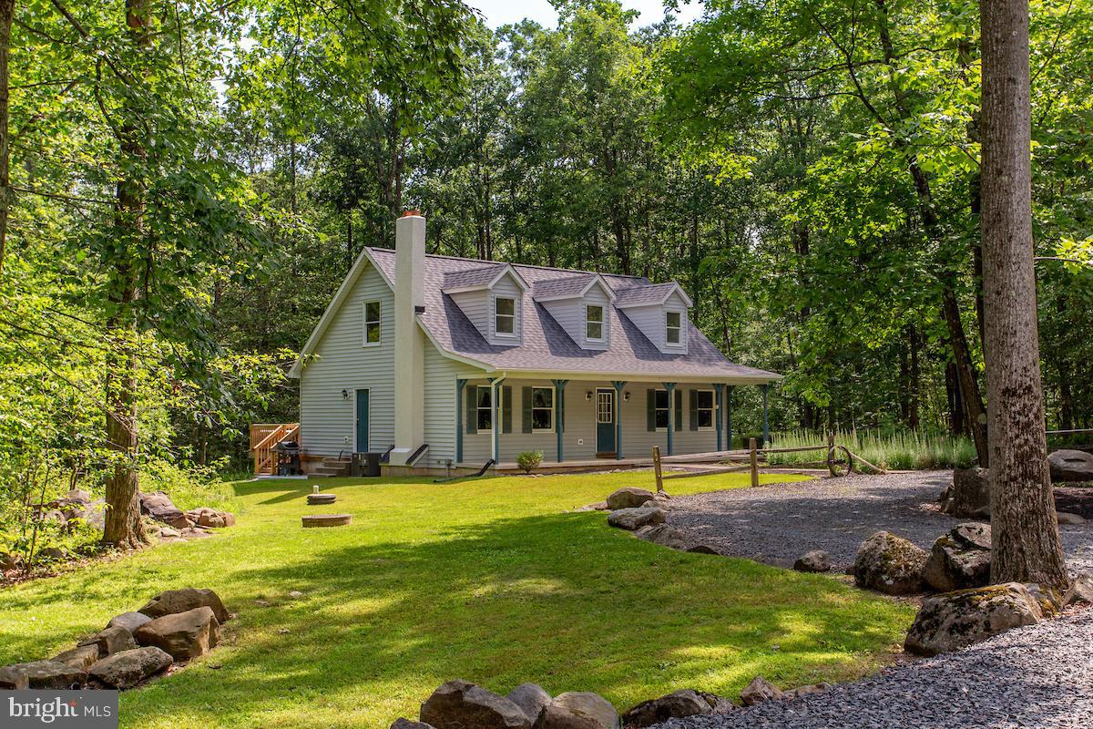 Discover the perfect blend of privacy, potential, and country charm with this exceptional 8.8-acre property in  highly desirable Upper Black Eddy.  
The home offers a flexible floor plan with two bedrooms on the main level, along with two unfinished upper-level areas with closets and windows that require very little to complete, offering an easy opportunity to add additional finished living space. The home includes one finished main level full bathroom, while a second bathroom has already been framed and plumbed located in one of  the upper level rooms.  All bathroom fixtures and accessories included, making it even easier to finish.
The inviting living room is warmed by a Canadian wood-burning stove, creating the perfect place to gather on chilly evenings while adding to the home's rustic charm.
A detached two-car garage with 10-foot overhead doors provides ample space for oversized vehicles, equipment, or a workshop. Above the garage, a spacious loft offers excellent storage or the opportunity to create a workshop, hobby area, man cave, home gym, studio, or other flexible space to fit your needs.
Step outside and enjoy your own private retreat. The expansive 8.8-acre property offers endless opportunities to enjoy the outdoors and includes a private shooting range, which could also be used for archery, target practice, or other recreational activities. The hot tub is also included, providing the perfect place to relax and take in the peaceful surroundings. Located just down the road from Ringing Rock Park and less than 1½ hours from both New York City and Philadelphia, you'll enjoy the perfect balance of peaceful country living with convenient access to two major metropolitan areas. Well maintained and featuring a new roof and chimney completed in 2025, with the roof backed by a lifetime transferable warranty, this property is ready for its next owner to make it their own.
Brimming with character, space, and endless possibilities, this unique Bucks County property is the perfect place to create your dream country retreat.