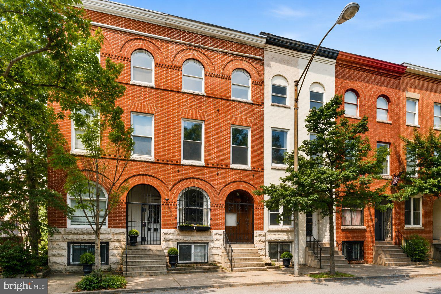Welcome to 1110 Guilford Avenue, where historic elegance meets modern comfort in the heart of Baltimore's iconic Mount Vernon Historic District. This stunning Federal style rowhome offers over 2,800 square feet of beautifully maintained living space across four finished levels, blending timeless architectural details with thoughtful updates in one of the city's most sought-after neighborhoods.

From the moment you enter, you'll be captivated by the soaring ceilings, rich hardwood floors, fresh paint throughout, intricate crown molding, graceful arched openings, exposed brick accents, and oversized windows that flood the home with natural light. Every room showcases the character and craftsmanship that make Baltimore rowhomes so beloved.

The spacious main level is designed for both everyday living and entertaining, offering an inviting flow from the living and dining areas into the generously sized kitchen. Complete with abundant cabinetry, expansive counter space, black appliances, gas cooking, and a breakfast bar, the kitchen provides the perfect space for preparing meals and gathering with family and friends.

Upstairs, you'll find four generously sized bedrooms filled with natural light, including a beautiful primary suite featuring elegant arched windows. The main bathroom has been refreshed with stylish luxury vinyl plank flooring, complementing the home's timeless finishes while adding a modern touch.

The fully finished lower level expands your living space with endless possibilities, whether you envision a family room, media room, home office, fitness area, or guest retreat.

Step outside and discover one of the greatest advantages of this exceptional home—its location. Situated in the heart of Mount Vernon, you'll enjoy an incredibly walkable lifestyle with museums, art galleries, neighborhood cafés, restaurants, local farmers markets, Penn Station, grocery stores, and some of Baltimore's most treasured cultural attractions just moments from your front door. Whether you're spending a Saturday exploring the neighborhood, meeting friends for dinner, or taking in a show downtown, you'll love having the very best of city living right outside your doorstep.

Combining historic charm, spacious living, thoughtful updates, and an unbeatable location, this home offers a rare opportunity to own a truly special home in one of Baltimore's most vibrant and beloved communities.
