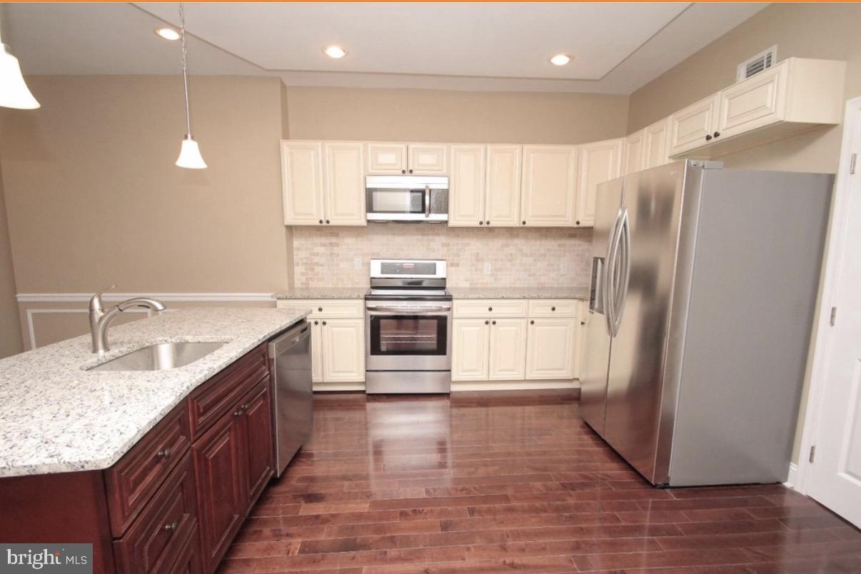 Great location in popular Walnut Hill! This very spacious twin offers a friendly front porch, high coffered ceilings with recessed lighting, large open floorplan on the first level, a beautiful flow from Iiving room, dining room and kitchen!  Easy, convenient every day living and the perfect space to entertain.  The beautifully designed kitchen boasts an elegant coffered ceiling with pendant lights, stainless steel appliances, large island, tiled back splash, custom cabinetry, pantry closet and beautiful granite countertops.  The convenience continues to main level laundry, mud room and powder room.  The fenced in back yard is perfect for grilling or just a little R&R.  Second level includes three large bedrooms with ample closet space and a large full bath.  The master bedroom has light filled bay window, great closets, high ceilings and a luxe master bath with walk-in shower. A short walk or ride takes you to the campuses of the best universities in the country.  City parks and public transportation nearby.