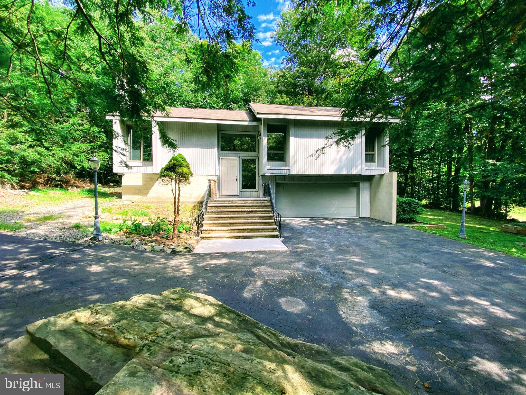 Located among a golf course, fishing spots and pools, tennis courts, water sport amenities. This modern, 3 bed 2.5 bath ,upgraded, and updated home features,  a fireplace in the living room, and a heated sunroom, with walkout to a full size deck, perfect for entertaining guests! Hard flooring throughout the first floor, a master bedroom with full bath. Lots of storage space and closets. Lower level includes a walk out basement with additional bathroom and room. Comes with a complete home warranty at closing.