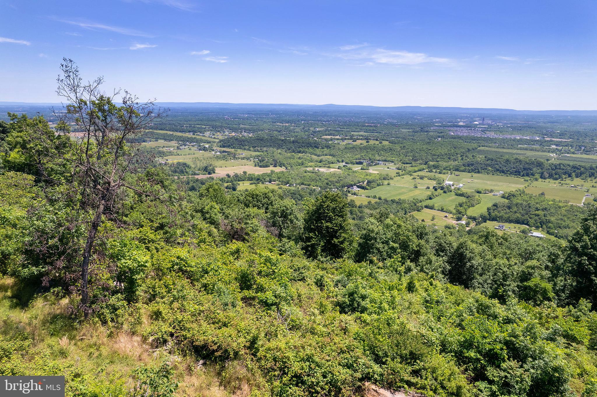 Views, views, views!  Fantastic opportunity to own a slice of heaven at the top of Shenandoah Overlook. If you have been looking for land with spectacular views, well, this is it! Build your dream home to capture the breath taking views of the surrounding mountains and plains of Berkeley County.  Enjoy the peace and quiet of mountain living while being a short distance to surrounding WV and VA towns. Conveniently located from the property are the towns of  Martinsburg, Winchester, Berkeley Springs, Shepherdstown and Charles Town for shopping, dining, wineries, and outdoor activities.  Roughly 80 miles from DC, this property would also make a perfect second home getaway. The property has a gravel driveway and the build area is cleared. Temporary electrical service for construction is already in place. Your slice of heaven awaits!