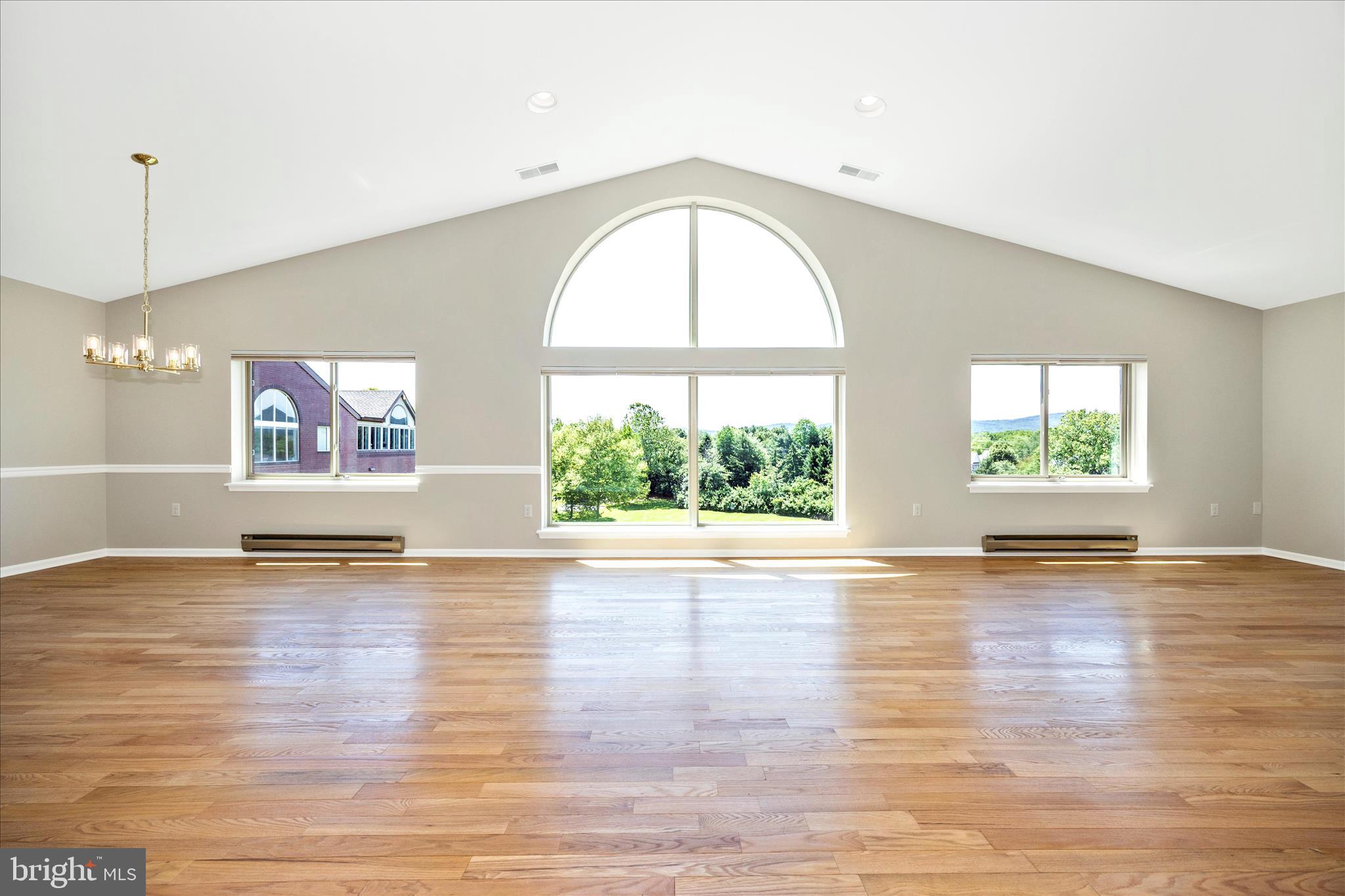Experience luxury penthouse living in one of Frederick's most desirable locations. Perfectly positioned at the edge of Baker Park, this exceptional Fairfield condominium offers the rare combination of over 3,000 square feet of elegant living space, breathtaking mountain views, and walkable access to downtown Frederick's restaurants, boutiques, breweries, distilleries, and Carroll Creek—while remaining comfortably removed from the late-night activity.

From the moment you arrive, you'll appreciate the convenience of a designated parking space in the secure underground garage complete with private caged storage. Take the elevator to the fifth floor, shared by only three residences, and step through the front door to a stunning view of the Catoctin Mountains framed by a dramatic Palladian window.

Freshly painted in a sophisticated neutral palette and enhanced by newly refinished hardwood floors, this penthouse is both timeless and move-in ready. The expansive living and dining rooms are filled with natural light from floor-to-ceiling windows and feature custom built-ins and a striking three-sided fireplace that creates warmth and architectural interest throughout the space.

A private library, complete with built-in shelving and a rolling library ladder, offers the perfect retreat for reading, working from home, or displaying treasured collections. Accessible from both the main hallway and through French doors from the living room, it is a room that is as functional as it is impressive. 

The spacious kitchen is designed for everyday comfort and entertaining alike, featuring granite countertops, soft-close cabinetry, abundant storage, generous prep space, and under-cabinet lighting. A conveniently located powder room and centrally positioned laundry room with utility sink add to the thoughtful design of the home.

Both bedroom suites offer exceptional privacy and comfort with large walk-in closets, private ensuite baths, and direct access to a sunroom. Whether enjoying morning coffee, a favorite book, or views of the changing seasons, the sunrooms provide a peaceful extension of the living space. 

Recent improvements include fresh paint throughout, refinished or newly installed wood floors, updated lighting fixtures, ceiling fans, electrical outlets, toggle slide dimmable light switches, and a high-efficiency heat pump installed April 2026 with a transferable 10-year warranty.

Rarely does a penthouse of this size, quality, and location become available. Offering low-maintenance living, secure parking, generous storage, and immediate access to Baker Park and downtown Frederick, this is a unique opportunity for buyers seeking luxury, convenience, and an exceptional lifestyle.