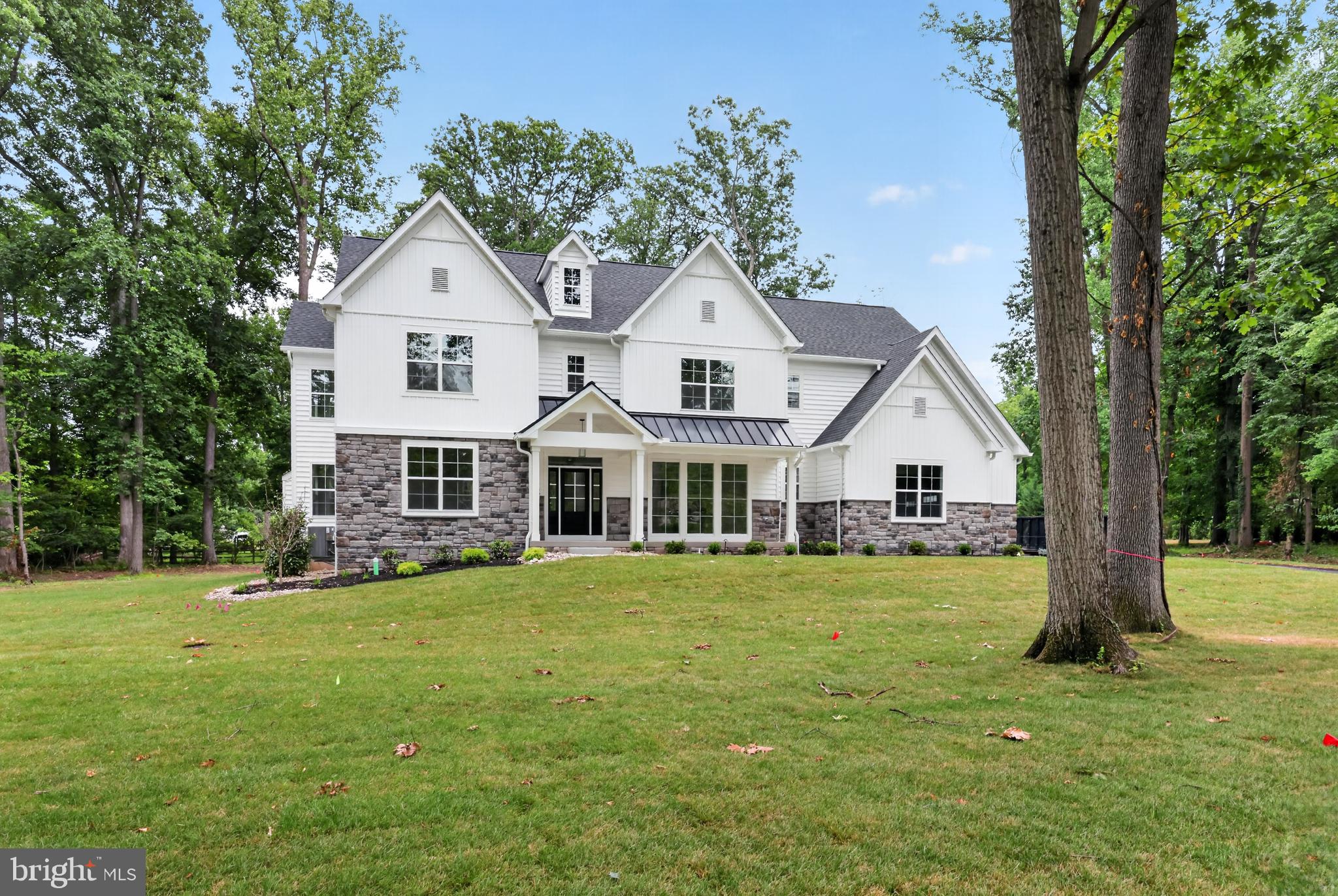 Welcome to your dream home! Nestled on a beautiful 1.7-acre lot in prestigious Lower Gwynedd, this exceptional new construction home by Marc Salamone Homes offers the perfect blend of luxury, space, and craftsmanship. Highlights include a gourmet kitchen featuring a large center island and top-of-the-line appliances, including two ovens—ideal for both everyday living and entertaining. The open-concept kitchen and dining area flow seamlessly into an expansive two-story family room, creating a bright and inviting main living space. Step outside to a spacious deck, perfect for outdoor dining, relaxing, or entertaining while overlooking the picturesque property. The home also features a irrigation system, helping to keep the professionally landscaped grounds lush and beautiful with ease. The first floor showcases hardwood flooring throughout and includes a welcoming foyer, formal dining room, private study perfect for a home office, sunlit breakfast area, walk-in pantry, mudroom with access to the attached three-car garage and driveway, and a conveniently located powder room. Upstairs, retreat to the impressive Owner’s Suite featuring a generous walk-in closet with built-ins and a luxurious en-suite bath complete with a soaking tub, oversized shower, and dual vanity. Three additional spacious bedrooms, two full bathrooms, and a second-floor laundry room complete the upper level. Built-in custom closets throughout. Located in the highly sought-after Wissahickon School District, this home offers the best of modern living in a serene suburban setting. Schedule your showing today!