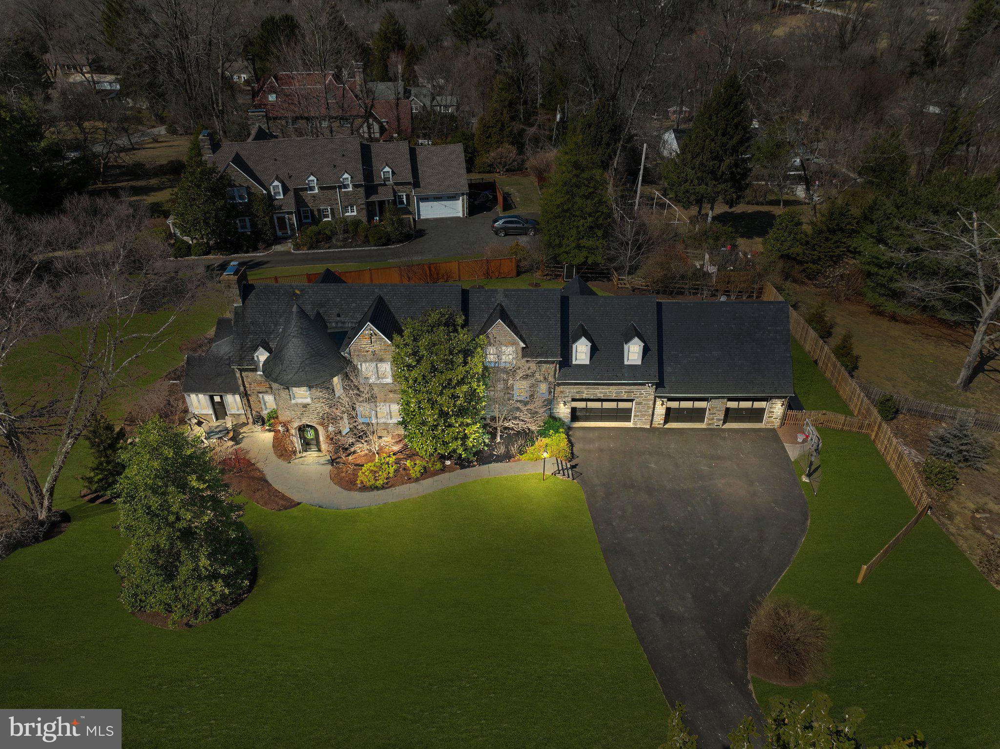 This extraordinary Jenkintown home went under a total home renovation in 2023 seamlessly blending modern upgrades with its timeless original charm truly making it one of a kind. Nestled on a one acre picturesque corner lot with mature trees, this stunning stone residence offers a serene retreat while exuding unmatched curb appeal. From the moment you arrive, the castle-like turret entrance and expansive stone façade make a lasting impression.

Step through the arched main doorway into a welcoming foyer with elegant stone flooring, offering ample space for furniture to create a cozy yet grand entrance. Designed for effortless entertaining, the main level boasts clear sightlines from end to end, complemented by brand-new light-toned hardwood flooring, recessed lighting, and a fresh neutral color palette that brightens every space.

The inviting living room features an oversized gas fireplace, perfect for cozy winter evenings. Flanking the fireplace, glass-paneled doors lead to an expansive sunroom with a newly vaulted ceiling and automated window treatments. A charming farmhouse-style door from the sunroom opens onto an inviting patio, beautifully lit by bistro lighting—an ideal spot for outdoor gatherings.

Adjacent to the living room, the spacious dining area comfortably accommodates seating for eight, with additional space for lounge furniture—perfect for an after-dinner cocktail. The heart of the home, a breathtaking chef’s kitchen, showcases an 11-foot seamless quartz center island, a dedicated coffee or bar area with a built-in beverage fridge, and custom cabinetry. A newly carpeted secondary staircase off the kitchen provides convenient access to two additional bedrooms and a hall bathroom.

Completing the main level are a stylish powder room, multiple storage closets, and access to the basement through a pocket door.


Upstairs, the primary suite is a true sanctuary, featuring a cozy fireplace, an upgraded en-suite bath with an oversized shower, and an incredible walk-in closet with custom built-ins. Down the hall, two additional bedrooms share a beautifully updated Jack and Jill bathroom, while a private guest suite—with its own full bath—sits at the far end of the home. Accessible via the kitchen staircase, this secluded space is perfect for an au pair, in-laws, or visiting guests.

Unparalleled Garage & Bonus Spaces
The home’s three-car garage is a standout feature with limitless possibilities. Bay #1 is heated with extra-tall ceilings—perfect for a home gym, classic car storage, or even a golf simulator. Bays 2 and 3 are spacious and connected, offering a full staircase leading to a massive loft spanning the width of the garage. Whether transformed into a game room, home office, or creative studio, this bonus space is brimming with potential.

1300 Gilbert is conveniently located to septa regional rail transportation making it a breeze to get into center city or other points of interest. It is also close to major shopping areas such as The Fairway and downtown Jenkintown where you can enjoy excellent dining options and a variety of small businesses. 

Don't hesitate to schedule your tour of this immaculate home before it's gone!

Additional Upgrades:
Newer Hot Water Heater (2022) 
Routine Roofing Repair and Maintenance (2023)
Fence (2024)
All New Pella Windows  (2023) (Exception of basement and downstairs garage windows)
New Driveway (2023)
Completed Updated Electrical (2023)

Additional Highlights:
Slate Roof – Timeless durability and character
Oversized Slate-Top Window Sills – A refined architectural touch
Completely Fenced Backyard (2024) – Private and pet-friendly
Gas Fireplace - makes starting a fire a breeze 
Automated blinds in sunroom - provides sunlight or full privacy in just a few seconds