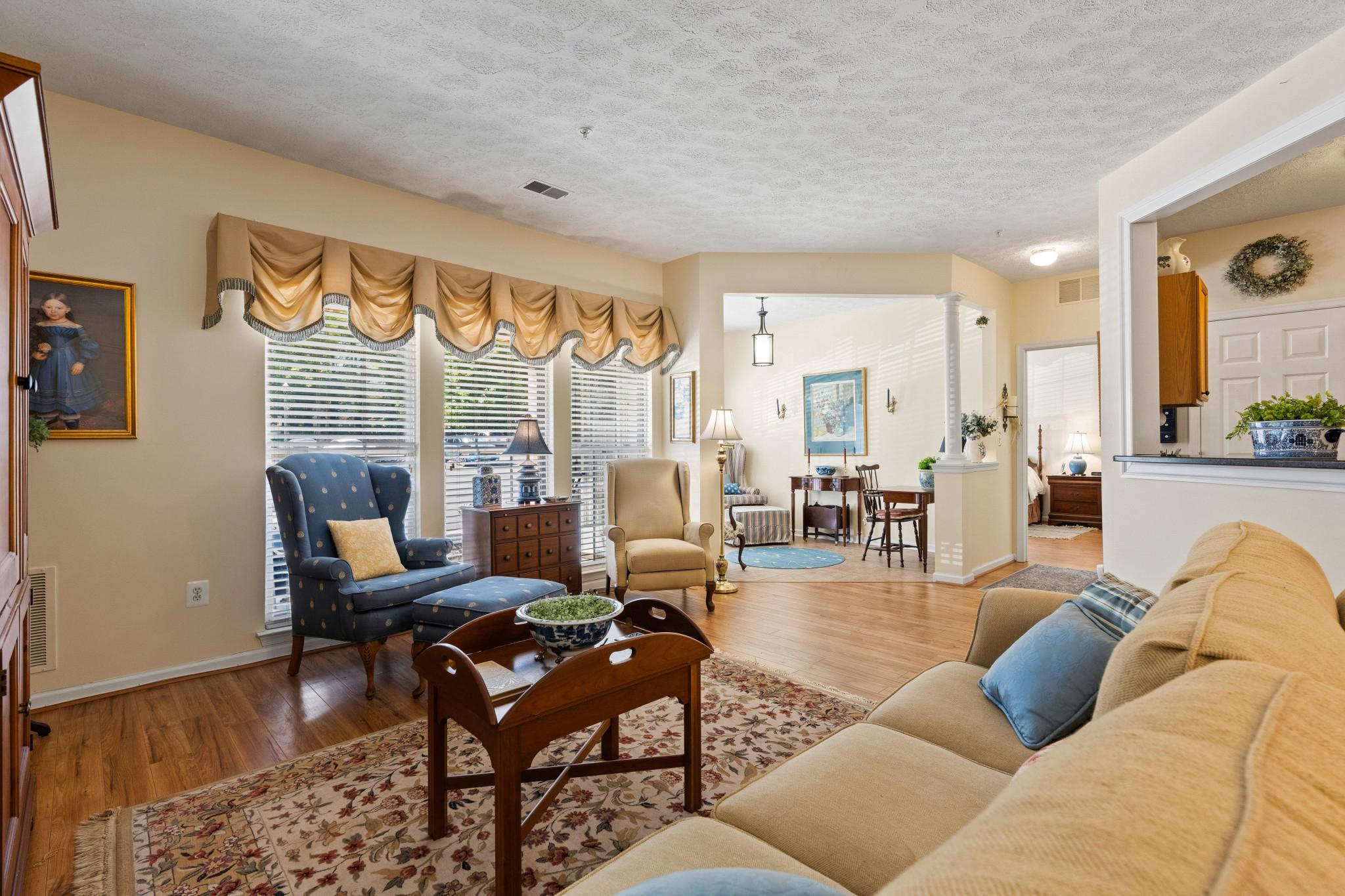 Nestled in the charming Village Green community, this delightful 2-bedroom, 2-bathroom unit offers a perfect blend of comfort and convenience . Built in 2004, the traditional design features an attractive brick and vinyl exterior, inviting you into a well-maintained space that feels like home. Step inside to discover an open floor plan that seamlessly connects the living and dining areas, enhanced by crown moldings and beautiful wood flooring. The country-style kitchen boasts upgraded countertops and stainless  appliances, including a refrigerator, stove, dishwasher, and disposal, making meal prep a joy. The convenience of in-unit laundry with a washer and dryer adds to the ease of daily living. Retreat to the spacious primary bedroom ensuite, with double closets including a walk in closet, ensuite bath with double bowl vanity and walk-in shower. The sun filled den provides flexibility for guests or a home office.  Second bedroom has access to hall full bath for added privacy and convenience. Thoughtful features like an intercom system enhance your comfort and security. Outside, the community offers well-maintained common grounds and your own private patio. With included amenities such as lawn maintenance, snow removal, and trash services, you can spend more time enjoying your home and less on upkeep. This inviting residence is not just a place to live; it's a place to thrive. Experience the warmth and convenience of Village Green living today!