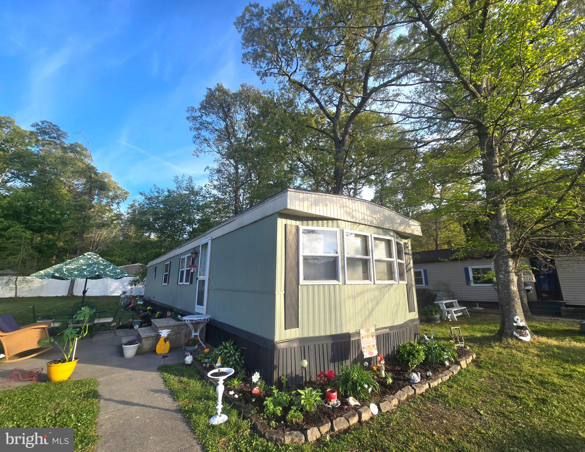 Presenting move in ready Budd Model 2 beds, 1 bath located less than 8 miles to Lewes Beach,  Rehoboth Canal, and less than 2 miles away from a pier dock with kayak launch and boat slips with easy access to Love Creek.  This cozy mobile home located in Cherry Creek Valley Subdivision estimated 840 sqft of space with backyard fenced.  Land lease is currently $499 per month.  Buyers are contingent on park approval owner/ seller is real estate licensee in state of Delaware.   Cherry Creek Valley is in the sewer expansion district.  Home is not available for rent nor allowed to be rent out per park rules.  The mobile home is for sale "As Is."
Buyers will be responsible for the full dmv doc fee at settlements well as the other customary closing costs.  Surveillance in place to monitor/save recording.  Please discourage from showing up at Cherry Creek Valley Subdivision without a scheduled showing.   All showings must be accompanied by the buyer's real estate agent of their choice with buyer's agency signed per NAR and Sussex County Association of Realtors.  Thank you for showing your interest and we look forward to meeting future buyer of this one of kind fully furnished mobile home.  Brand new roof installed in October of 2025.  One window unit for ac already in place in living/kitchen area.  In addition to working central air & gas heat.  Stainless steel Whirlpool refrigerator and GE Stove included.