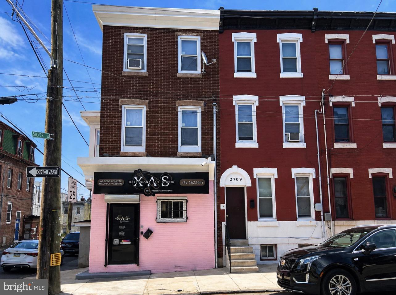 2711 N. 11th St presents an exceptional mixed-use investment opportunity with commercial zoning and strong income-producing potential. This recently renovated property features a ground-floor commercial space currently operating as a salon, offering immediate business or rental use in a high-visibility location. Above the commercial unit, the second floor includes a beautifully updated 2-bedroom, 1-bath apartment, while the third floor offers a spacious renovated 3-bedroom residential unit. All units have been thoughtfully upgraded, creating a turnkey opportunity for investors or owner-occupants alike. The property also includes a private yard, adding valuable outdoor space, while the unfinished basement with its own private side entrance provides additional storage or future expansion possibilities. Whether you’re looking to expand your portfolio, operate your business below, or maximize rental income, this versatile mixed-use property offers endless potential.