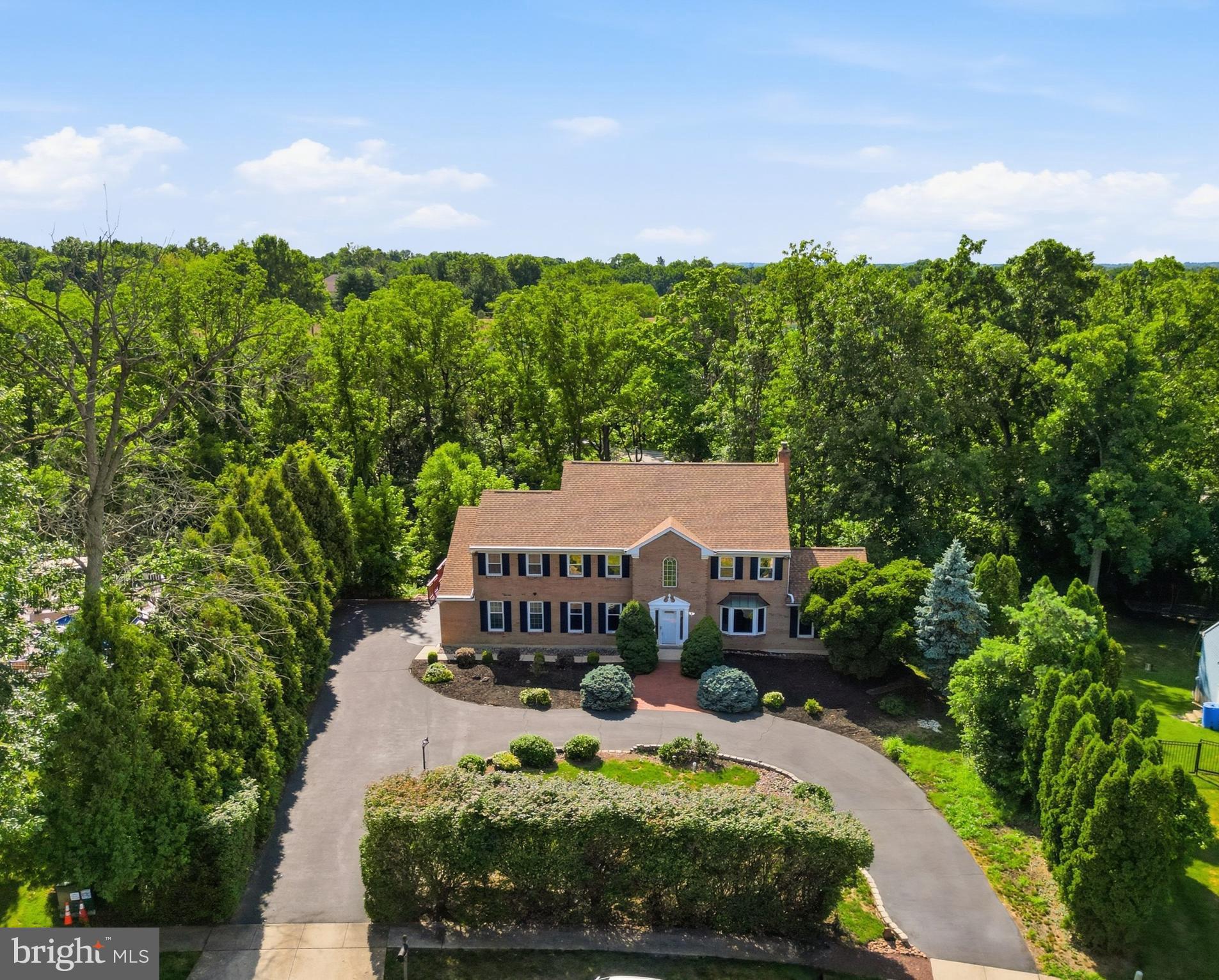 Welcome to 962 Musket Drive, a colonial style home tucked away on a quiet cul-de-sac in Upper Gwynedd Township. Set on a picturesque 0.95-acre lot, this impressive home offers over 3,650 square feet of well-designed living space with five bedrooms, three full bathrooms, and a powder room. A wraparound driveway, mature landscaping, and a welcoming front entrance create an inviting first impression, while the thoughtful floor plan offers the perfect balance of formal and casual living spaces. The main level features formal living and dining rooms, a spacious family room, a sun-filled breakfast area, and a kitchen with abundant cabinetry, generous counter space, tile flooring, and an adjoining sunroom overlooking the backyard. A first-floor bedroom with a full bathroom, along with a convenient powder room, adds flexibility to the main level.

The second floor is highlighted by a spacious primary suite complete with a large sitting room, walk-in closet, and a primary bathroom featuring skylights, a soaking tub, and a separate shower. Three additional generously sized bedrooms and a full hall bathroom complete the upper level. The finished lower level provides additional living space with a recreation area, abundant storage, and a built-in package delivery system that adds everyday convenience. 

Outdoor living is equally impressive. The expansive wraparound wood deck provides plenty of space for entertaining, dining, or simply enjoying the peaceful setting. Beyond the deck, a charming bridge leads to an extended backyard, creating a unique outdoor space with room to relax, play, garden, or enjoy the natural surroundings. A two-car garage with additional storage completes the home's interior amenities. This is a prime location just minutes from shopping, dining, parks, and major commuter routes, 962 Musket Drive is a wonderful opportunity to own a home in one of Upper Gwynedd's most established neighborhoods. Listed & Marketed by Lacy Peacock - Keller Williams Real Estate