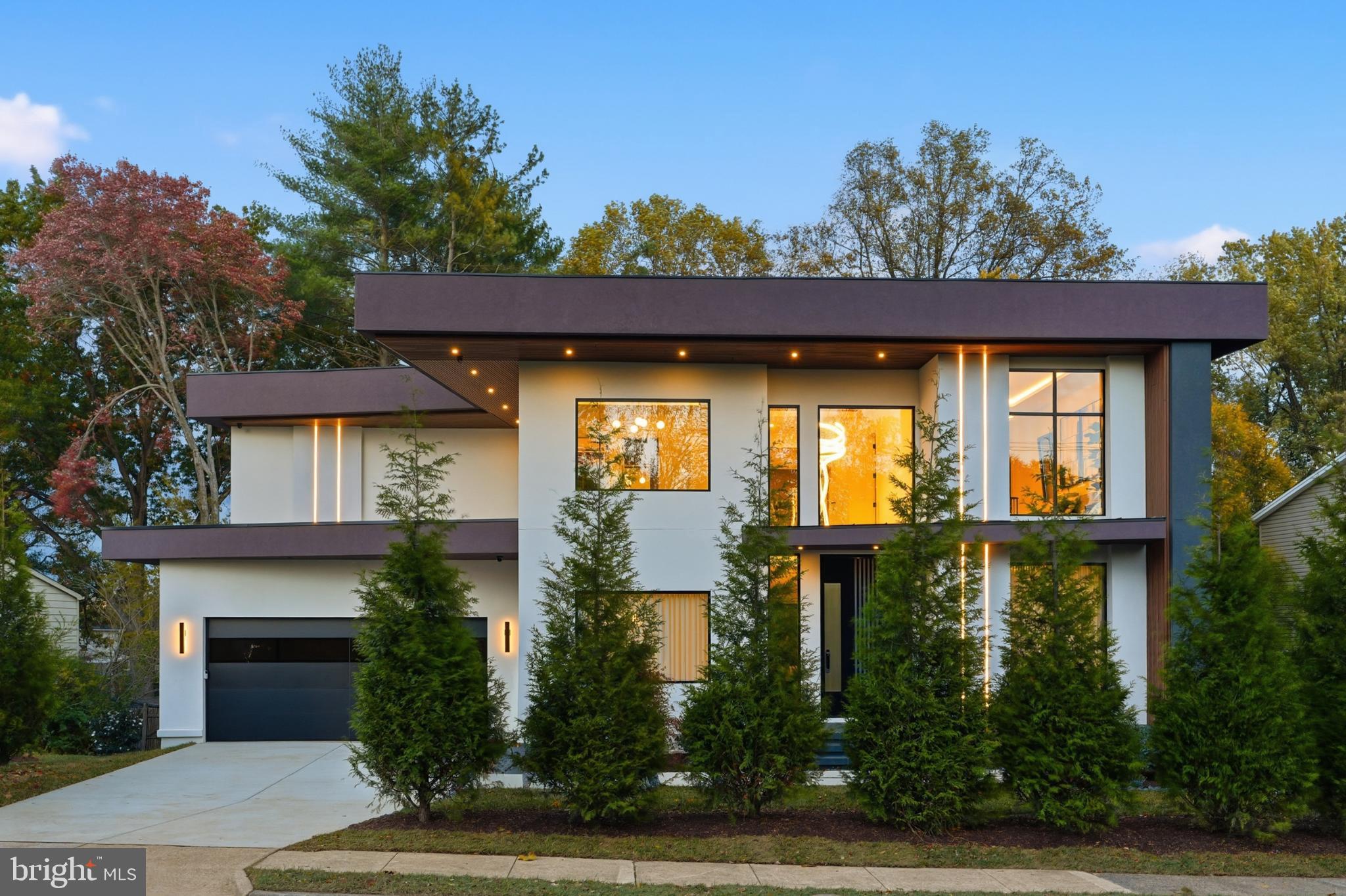 Model Home Now Open! Stop by to design your dream home or choose from one of our available model options! Welcome to Nirvana House – The Pinnacle of Modern Luxury Living! Located in the heart of Vienna, Virginia, Nirvana House is a modern architectural masterpiece that redefines the meaning of contemporary luxury. Set on a lush 16,417 SF lot, this residence spans over 7,972± square feet of inspired design, blending refined elegance, cutting-edge technology, and everyday functionality.

Just minutes from Tysons Corner, this exceptional home offers the perfect balance between urban sophistication and suburban tranquility.

Main Level – Seamless Living & Entertaining

Spanning 2,530± square feet, the main level welcomes you through a 10-foot pivot glass door into a two-story foyer framed by steel-and-glass floating stairs and floor-to-ceiling European windows that fill the home with natural light.

Designed for effortless flow, the main level features a private home office, formal living and dining rooms, a breakfast nook, and a stunning modern kitchen with European cabinetry, an oversized island, and sleek finishes. A spice kitchen, walk-in pantry, custom-built mudroom, and dedicated pet shower elevate convenience to luxury.

A 17-foot sliding glass wall opens to a covered terrace featuring porcelain tile flooring, a fireplace, integrated speakers, wood ceiling, and glass railings with steps leading to the backyard — creating a seamless indoor-outdoor living experience. 10 feet main level ceiling height, emphasizing openness and grandeur.

Upper Level – Private Serenity

The upper level, offering 2,912± square feet, is a sanctuary of privacy and comfort. It features four ensuite bedrooms, each with custom walk-in closets and spa-inspired bathrooms.

The owner’s suite is a true retreat, showcasing dual European walk-in closets, a luxurious spa like bath with heated floors, floating dual vanities, custom lighting, a smart water closet, rain shower, and a sculptural freestanding tub. Step outside to the private covered balcony finished with porcelain tile and glass railings, ideal for tranquil mornings or nights.

Upper Level Additional highlights include 10-foot ceilings, an elevator shaft, and a designer laundry suite with an elevated washer and dryer — the kind of detail you’d expect to find only in a magazine.

Lower Level – Wellness & Entertainment

The lower level, spanning 2,530± square feet, is the ultimate leisure and wellness haven. Featuring 9-foot ceilings and abundant natural light, this fully walk-out level includes a recreation lounge, custom wet bar, wine display wall, fitness room, steam shower, dry sauna, and a powder room. An additional bedroom with ensuite full bath and walk-in closet offers perfect guest accommodations. A covered patio extends the entertainment space outdoors.

Every inch of Nirvana House speaks to excellence in craftsmanship and design. The exterior is finished with smooth stucco exteriors, architectural accents, and exterior LED lighting that defines its striking silhouette.

Inside, 10-inch European white oak engineered flooring flows throughout upper 2 levels, complemented by custom built-ins, European cabinetry, and modern gas fireplaces that bring warmth and elegance to key living spaces.

Nirvana House is also a has smart home features, allowing you to control lighting, sound, cameras, and more at the touch of a button — luxury and convenience intertwined.

Prime Location

Perfectly positioned for both work and play, Nirvana House sits just: 1.5 miles from Tysons Corner, 20 minutes to Washington, D.C., 14 miles to Reagan National Airport, 14 miles to Dulles International Airport, 10 miles to River Bend Golf & Country Club

Step into the future of modern luxury. Step into Nirvana House. Additional homesites available upon request.