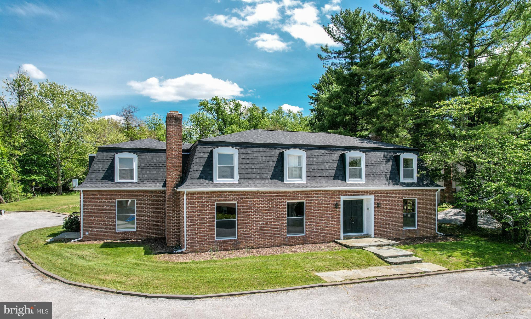 Welcome to 919 Winchester Drive.  This magnificent, one-of-a-kind custom-built brick home is a true masterpiece of craftsmanship and design, offering 4,300+ square feet of luxury living space. Situated in a sought-after neighborhood, this home blends timeless elegance with modern convenience, making it the perfect retreat for families seeking comfort, style, and functionality.
The classic Mansard roof stands out, showcasing architectural sophistication and creating a striking first impression. Entering the home, you're greeted by a grand foyer that opens into the expansive living and family areas.
The main level features a family room, a true centerpiece, featuring a wood-burning fireplace that adds warmth and charm to the space. High ceilings, recessed lighting, and large windows fill the room with natural light, offering a comfortable and inviting space for gatherings. This room includes a huge walk-in closet with custom shelving that is perfect for storing all holiday decorations or family games.   A large home office with custom built shelving is located right off of the grand foyer.  The dining room includes a beautiful bay window overlooking a large hardscaped patio and stacked stone wall providing the perfect backdrop for a casual meal or an evening dinner party with friends & family.  The living room adjacent to dining room mirrors the family room in its size and layout, featuring a wood-burning fireplace for even more space for relaxation or entertaining.  Recessed lighting on the first floor adds an elegant touch, creating an inviting ambiance. 
The heart of the home boasts a new 21' x 16' kitchen, designed with both form and function in mind. It offers ample cabinetry, granite counter tops and stainless steel appliances, making it a chef's dream. A sliding patio door off kitchen opens up to a cozy sunroom for morning coffee or an evening drink.
Adjacent to the kitchen, a large laundry room features a separate entrance, ideal for easy access from the outdoors or garage. This laundry room is not just practical, but designed with style and convenience in mind, offering custom built lockers for your children's coats, backpacks, and sports gear – keeping the family organized and the home clutter-free.  The main level also features a bonus room perfect for a bedroom for guests, au par or family member.
Moving up to the second floor, you'll find spacious bedrooms with oversized closets, including a dedicated cedar closet for seasonal storage or specialty items. With six generously sized bedrooms, including a primary suite designed to be a peaceful retreat, this home offers ample space for every member of the family.
The primary bedroom features a tranquil atmosphere with abundant space for rest and relaxation. With an ensuite bath, it has everything needed for privacy and luxury.
In addition to the aesthetic details, this home features two staircases for easy access to the second floor, enhancing the flow and accessibility between levels.
Outside, the hardscaped patio provides a serene spot to relax and entertain, offering picturesque views of the lush surroundings. Whether hosting a summer BBQ or enjoying a quiet morning coffee, this outdoor space provides the ideal setting for every occasion.
This exceptional home is not only a sanctuary but also an ideal space for family living, offering the perfect blend of form and function. From the thoughtfully designed layout to the stunning architectural details, every inch of this property reflects the highest standards of luxury living.
Enjoy the convenience of being just minutes away to historic downtown Westminster for dining, shopping, festivals and holiday events, Carroll County Farm Museum and Carroll County Ag Center hosting many yearly events, the Life Bridge Hospital and McDaniel College for college football and artistic events .
* NEW ROOF 2025! FRESHLY PAINTED THROUGHOUT! 2025 NEW KITCHEN AND MANY BATHROOM UPDATES!