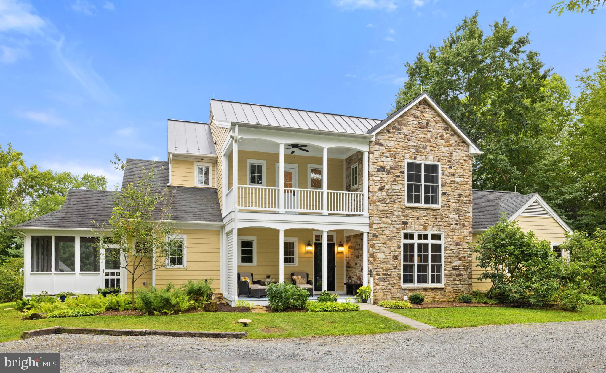 Welcome to Bluebird Haven! Tucked away among mature trees just minutes from the historic village of Middleburg, this beautifully crafted colonial home offers over 5,300 square feet of gracious living space across three levels. Sited for optimal Southern exposure, the home combines timeless charm with sustainable planning, ensuring natural light, privacy and energy efficiency. The floor plan was intentionally designed for comfort and longevity, featuring two spacious primary bedroom suites - one on the main level and one upstairs - ideal for multigenerational living or aging in place. The main level includes wide doorways, a roll-in shower and has been prepped for a future elevator. The home boasts reclaimed oak and chestnut flooring, soaring 9’+ ceilings, Marvin windows and a stunning floor-to-ceiling stone fireplace with a Hearthstone woodstove as the heart of the open living room area. The gourmet kitchen is a chef’s dream, complete with high-end stainless-steel appliances, custom soft-close cabinetry, a walk-in pantry, leathered dark marble countertops, an antique porcelain farm sink and an island with a secondary prep sink. Just off the kitchen, the dining area is illuminated by a striking 3-light Loblolly Goods chandelier, one of two thoughtfully chosen pieces that enhance the home's custom character. Upstairs, a separate laundry room adds practicality, while the lower level offers abundant potential with unfinished spaces designed for a recreation room, home gym, and workshop. It’s also plumbed for a future half bath. Enjoy the outdoors year-round from the screened-in porch, flagstone fire pit area, or amongst the raised garden beds. Additional features include a 2nd story open balcony, chicken coop, built-in play set, garden shed, and barn doors and bathroom vanities handcrafted from oak trees milled right on the property. From concept to construction, this home was designed with purpose, comfort and attention to detail. Move right in and enjoy the best of hunt country living with the convenience of town just minutes away.
