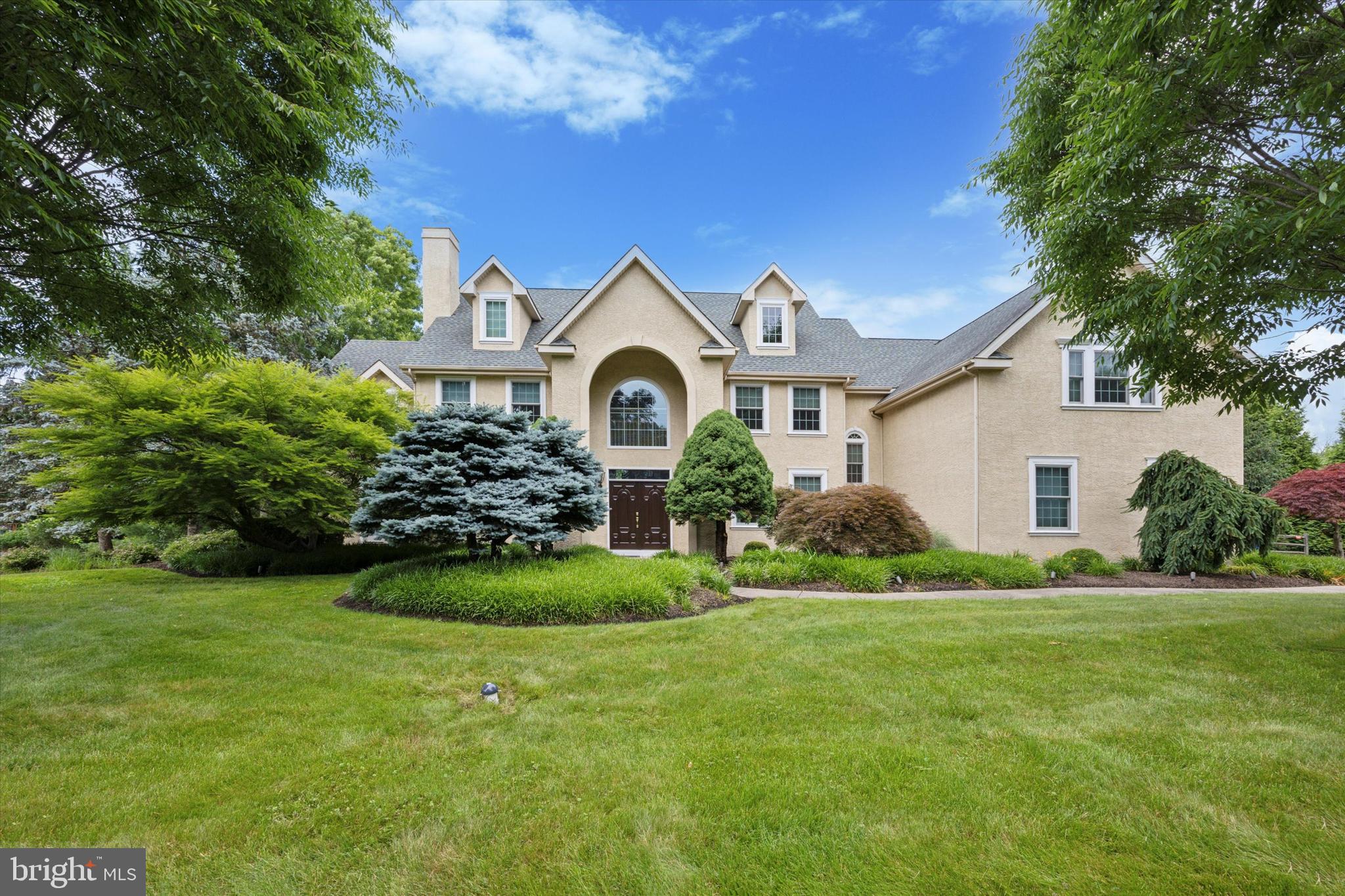 Welcome to this stately colonial home, nestled in the serene beauty of Hillcrest Meadows in Worcester Township and set on over 4.5 lush acres, The former model is a masterpiece of elegance and functionality, offering an unparalleled living experience.
As you enter through the grand two-story foyer, you will be captivated by the exquisite millwork and sweeping curved staircase. The spacious formal living and dining rooms exude sophistication, complemented by a convenient butler's pantry leading to a chef's dream kitchen. Outfitted with Viking appliances, upgraded cabinetry, a large granite center island, two-tone granite countertops, and a stunning Palladian window, the kitchen is the heart of this home. An expanded breakfast area with sliding glass doors opens to a maintenance-free deck, perfect for enjoying morning coffee or evening sunsets. 
The inviting family room features an 18-foot cathedral ceiling, a built-in entertainment center, a gas fireplace, and a wet bar, creating a cozy yet luxurious gathering space. Completing the main level are a private office, a cozy sunroom off the living room offering French doors to the side patio, a powder room, and a versatile laundry room with access to the kitchen, garage, and driveway.
Upstairs, the curved oak staircase leads to an extra-wide hall and balcony overlooking the foyer and family room. The double-door entry opens to a sumptuous primary suite, a true retreat with a private sitting area, vaulted ceiling, gas fireplace, two walk-in closets, and a spa-like bathroom featuring a jetted soaking tub, stall shower, and dual vanities. A private bedroom suite with a full bathroom, two additional bedrooms, a shared hall bathroom, and an office/homework room with built-ins complete this level. The walk-up attic is ready to be finished to suit your needs.
The finished basement is an entertainer's dream, offering a wine cellar, kitchenette with sit-up peninsula, a half bath, and a walkout to the pool area. Oversized 3 car attached garage fully customized by Garage Tek. Outdoors, you will find a built-in pool and spa surrounded by immaculate landscaping, creating a private oasis for relaxation and recreation. Great Location in Methacton School District. Convenient to shopping, dining, parks, Merck and major routes. Don’t miss the opportunity to own this exceptional property. Schedule your private tour today and experience the charm and luxury of this beautiful home.