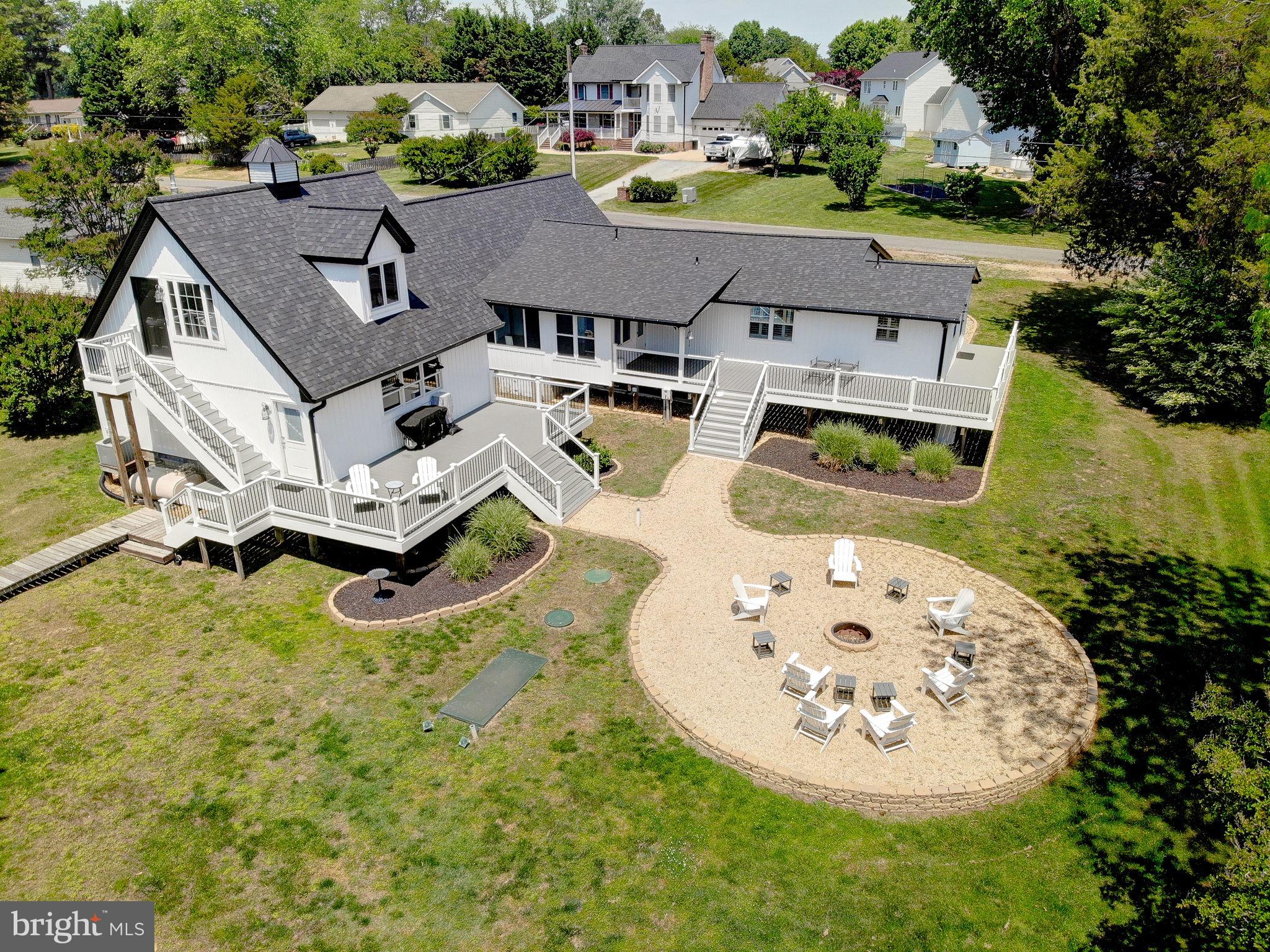 Seriously, what's not to love! The quiet setting with double decks are perfect for morning coffee, relaxing at the end of the day or entertaining as everyone will love the views of the water and the spacious backyard with built in fire pit. Inside, there is plenty of room for everyone! The garage has been converted to a large and open common space as it is temperature controlled. Enjoy movie nights, working out, playing games or whatever fits your life! There are 4 nice sized bedrooms, updated kitchen with a breakfast nook to enjoy views of the water. The updated kitchen makes it much easier to prepare your best recipes or gather with loved ones. The current seller has repainted and updated all the big items - septic, roof, siding and decking so you can just move in and relax! Conveniently located to Patuxent Naval Base, Dominion Cove, Solomons and so much more!
