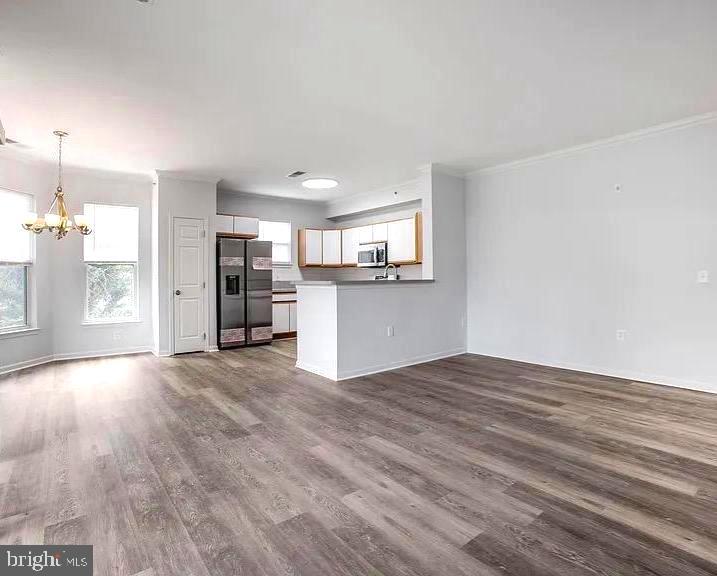 Welcome to this beautifully maintained 2-bedroom, 2-bath condo offering over 1,200 square feet of comfortable living space in a secure gated community. Thoughtfully updated and move-in ready, this spacious home features an open-concept layout enhanced by elegant crown molding throughout the main living areas, creating a polished and inviting atmosphere.

The bright living and dining spaces flow seamlessly to a private balcony, perfect for enjoying your morning coffee or unwinding after a long day. The generously sized bedrooms provide flexibility for guests, a home office, or roommates, while both full bathrooms offer convenience and functionality.

A major highlight is the extensive appliance package, with all kitchen appliances replaced in 2023, including the stainless steel Samsung refrigerator, gas range, microwave, and dishwasher. The home also includes a full-size washer (2026) and dryer, updated flooring, modern light fixtures, and a water heater replaced in 2022, providing peace of mind for years to come.

For first-time buyers, this home offers an exceptional opportunity to build equity instead of paying rent while enjoying the space and amenities often difficult to find at this price point. With its generous square footage, modern updates, and low-maintenance condo lifestyle, this property is an affordable path to homeownership in the Washington, DC metro area.

Residents enjoy the benefits of a gated community, secure parking with two permits, and access to a community fitness center. Conveniently located near Metro stations, I-495, shopping, dining, and entertainment, this home offers an easy commute to Washington, DC, Northern Virginia, and beyond.

Whether you're purchasing your first home, downsizing, or seeking a convenient commuter-friendly location, this well-appointed condo combines space, updates, affordability, and convenience at an exceptional value.