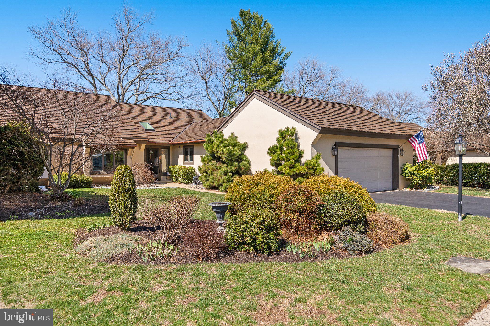 LOCATION, LOCATION , LOCATION. Welcome to 15 Springhouse Lane, a stunning carriage home with a million dollar view nestled in Whitpain Farm , a gated 55 + community, in the heart of Blue Bell. This is one of the largest residences in the community , both inside and outside, with over 2900 square feet of elegant living space on the main level and over 400 square feet of unobstructed finished space on the lower level, and 1000 square feet of stone paved surrounding outdoor patio.
The home is meticulously maintained and updated with a new CeDUR 50 year roof installed in 2023, an updated kitchen, patio, and the addition of a study. A full--house generator provides extra comfort and security. There is plenty of living space and ample storage. This exquisite 3 bedroom , 2.5 bath residence offers a harmonious blend of style and comfort across its 8 well-appointed rooms.

As you step inside, you'll be greeted by the inviting foyer that sets the tone for the elegance found throughout. The formal living and dining rooms provide plenty of space for entertaining and are surrounded by floor-to-ceiling windows and a French door. There is a spacious primary suite, complete with multiple custom closets and a luxurious bathroom boasting separate sinks and a jacuzzi tub. The home office is highlighted with built- ins and a wall of casement windows which provide warm natural light as well as a breathtaking view of the meadow and original Whitpain springhouse. There is a cozy family room complete with brightly lit windows and a gas fireplace. The kitchen is a chef's dream, equipped with granite countertops and stainless steel appliances including a Thermador double oven, a gas cooktop, a warming drawer and a refrigerator, all set within an eat-in layout that opens to a patio, all perfect for gatherings.There are rich hardwood floors that flow throughout the home. This exceptional home also boasts a guest suite with full bath, and a sunlit third bedroom with custom oak built-ins, which functions as a den or reading room.  Completing this home is a large powder room for guests as well as a full-sized laundry room, conveniently adjacent to the two car garage.

Step outside to your oversized private L- shaped patio with beautiful Oakville natural stone ideal for relaxation or entertaining guests and also overlooking the meadow view. Residents also have access to the manor house, the tennis courts, the community garden, and a communal pool, perfect for enjoying warm days.

There is plenty of parking with a large two car garage. Mature trees and a professionally designed garden further enhance the outdoor space. Experience the perfect blend of luxury and functionality in this beautiful Blue Bell carriage home with the dreamy views from the rear windows and patio. This elegant home boasts timeless architecture with an open concept, exquisite built-ins , and large windows will meet your needs from exercising to entertaining and gardening. The lovely home is conveniently located near major highways, commuter rail, a winery, theaters, restaurants and shoppes.
Don't miss the opportunity to make this your new home!