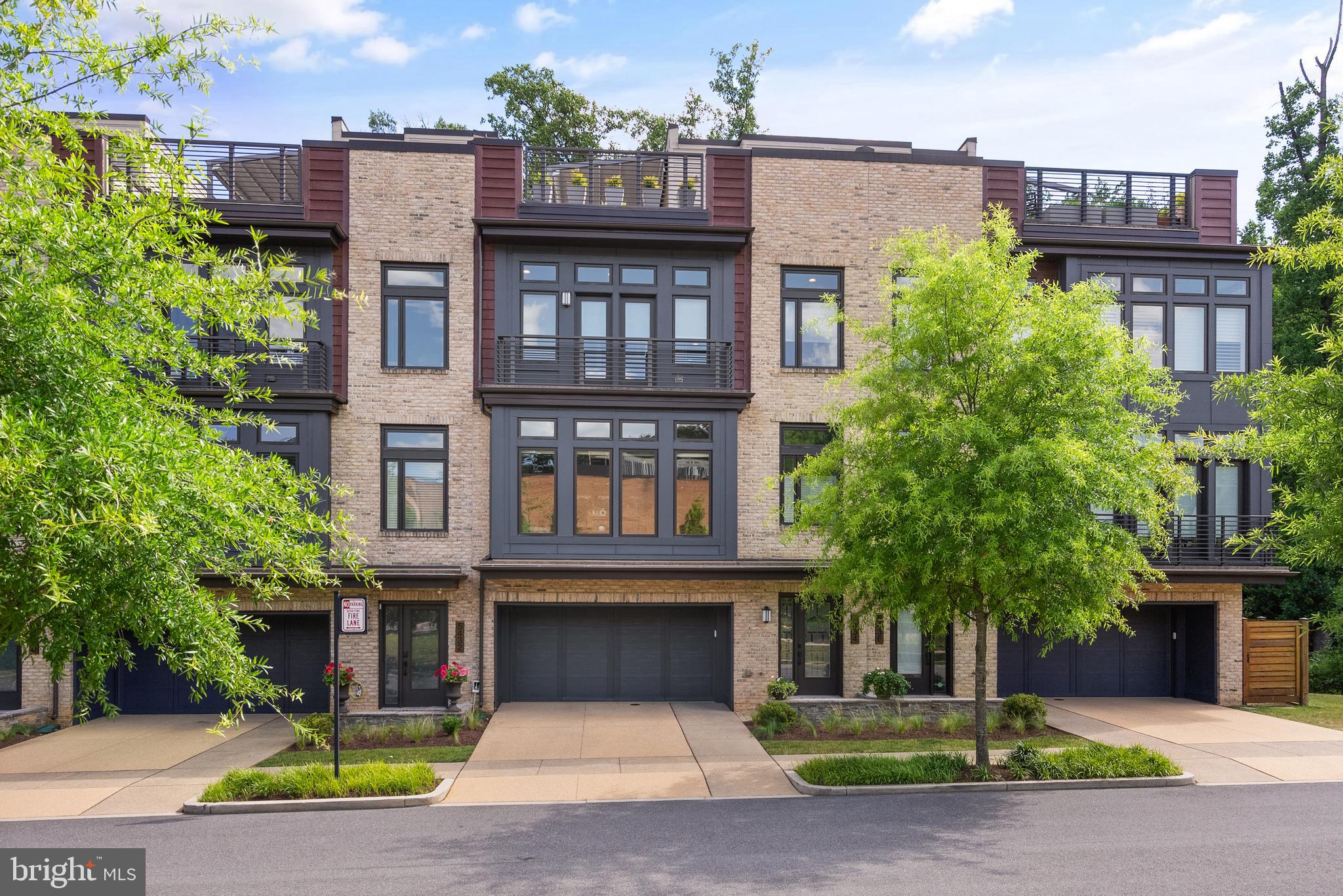 Prepare to be captivated by this stunning LEED Certified 4-bedroom, 3.5-bathroom townhome located in the sought after Grosvenor Heights subdivision. Spanning an impressive total of 4,489 square feet (3102 sq. ft. interior), this meticulously maintained property offers the perfect blend of modern luxury and unparalleled convenience. As you step inside, you'll be greeted by an airy layout with soaring 10-foot ceilings and recessed lighting that creates a warm, inviting ambience. The first-floor flex room/bedroom, with a private full bathroom, provides endless possibilities – transform it into a peaceful home office with views of the manicured zen garden in a private fenced back yard, a cozy guest suite, exercise room, or an additional living and entertaining space. The open kitchen boasts two Thermador ovens, Wolf SubZero refrigerator with custom cabinet-matched paneling, Bosch dishwasher, a vast center island with ample seating and counter space, and a separate counter/bar space. The dining area is surrounded by large windows and natural light, and the living room features a gas fireplace, and access to the private rear deck with a retractable awning, overlooking the serene scenery. Move up to the upper levels and discover the primary suite with custom designed dual closet, and spa inspired primary bathroom. Additionally, this floor offers hardwood flooring, two sunlit secondary bedrooms, full bathroom with upgraded soaker tub, and a conveniently located laundry room. But the wow factor of this property is the expansive rooftop deck, outfitted with a Corradi retractable roof pergola and an outdoor kitchen complete with a Viking mini fridge, wet bar, and gas hookup. Brazilian hardwood deck tiles complement the rooftop, creating an ideal space for outdoor living and entertaining. With an elevator for added convenience, and a 2-car garage with storage capacity, this home is designed to simplify your daily life, with easy low maintenance. Other features include Cat6 wiring in the living room with multiple ethernet direct wiring outlets, marble-look ceramic tile flooring in the lower level, custom stair rails throughout, whole house water filter, and Porcelanosa wood-look porcelain tile on three floors. Located within the prestigious Grosvenor Heights community, this luxury townhome offers the perfect balance of privacy and accessibility. Stroll through the lush green walking paths of Fleming Park, Bethesda Trolley Trail, and Rock Creek Trail, and conveniently access the red line Metro, major highways, Wildwood shopping center, Pike and Rose, Music Center at Strathmore, and more. Don't miss your chance to make this exceptional townhome your new sanctuary. Schedule a private tour today!