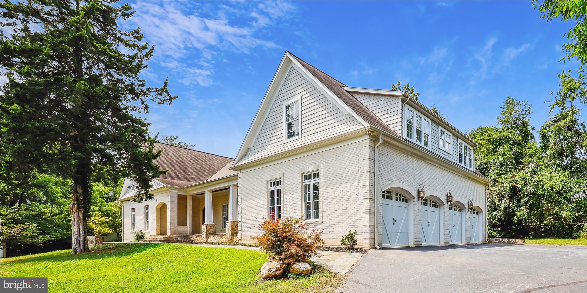 Welcome to this custom-built, 6,665 square foot (as per tax record/ photographer measures 7,200 square feet), home, featuring 2 lovely primary ensuites, having luxurious full baths and sitting rooms. Perfect for long-term visitors, or having an office suite! This executive finished brick home, is located in lovely/private Glen Hills.  Some features: in addition to 2 Primary Suites, (one on main level, (previously used as an office suite), the other on second level, sited on a private 1.12 acre private lot, having a flagstone hardscape  (walk-way, wall and seating), leading to a roofed flagstone veranda protecting the front door, (door having a wood-surround, side and upper transoms). The front porch is a covered veranda (stretching the length of the living room and kitchen), having 6 ceiling lights. This unique 5 bedroom, 5 full baths, 2 powder room home, is finished with: 3-piece crown moldings, 2-piece chair railing, new hardwood floors (main level), ceramic floors, 9', and tray ceilings, 6 panel doors and much more 

Main level: Gracious 2-story foyer faces a hardwood curved staircase, new hardwood floors, curved-walled living room and 2-sided fireplace. From the living room, pillars introduce you to a spacious dining room having tray ceiling and french doors, (surrounded by 2 large stationary french doors), leading to a flagstone patio.
A spacious gourmet country kitchen showcases stainless steel appliances, (double oven, 2 dishwashers, side by side refrigerator, wine cooler), built-in wine rack, 2 sinks (1 a double, the other a vegetable), large 2-tiered granite center-island and counter tops, custom cabinets, fireplace (double sided w living room), ceramic back splashes! Also featured, on the main level: library/den, 2 powder rooms, spacious family room w floor-to-ceiling stone fireplace and beamed ceiling, the first of the 2 spacious primary ensuites w adjacent large sitting rooms and luxurious primary baths (separate shower stall and soaking tub, double sink, ceramic floor/counter tops), second set of stairs, to private nanny suite, (on second floor). 
In addition to the previous there's a laundry/mud room, storage shelves, powder room and access to garage. 

The second floor features: second primary ensuite w large sitting room/room closet and luxurious full bath having separate shower, soaking tub, double sink, linen closet, travertine floor and marble counters, 2 guest/children's suites have private full baths. There's access to a 2-room, nanny ensuite (accessible by 2nd. staircase, near kitchen), utility room containing second HVAC system. 

The 3-car attached garage has a 4th. door to facilitate lawn mowers and other small equipment. 

The walk-out lower-level features: Spacious family room w ceramic floors, double doors to rear yard, den (unfinished/ previously used as a media room) and storage/utility room having 1st. of two HVAC systems.
 
This home is close to Shady Grove Edu and Medical facilities, shopping and schools and conveys a 1-year Cinch Home Warranty Protection plan covering appliances, HVAC system and much more.