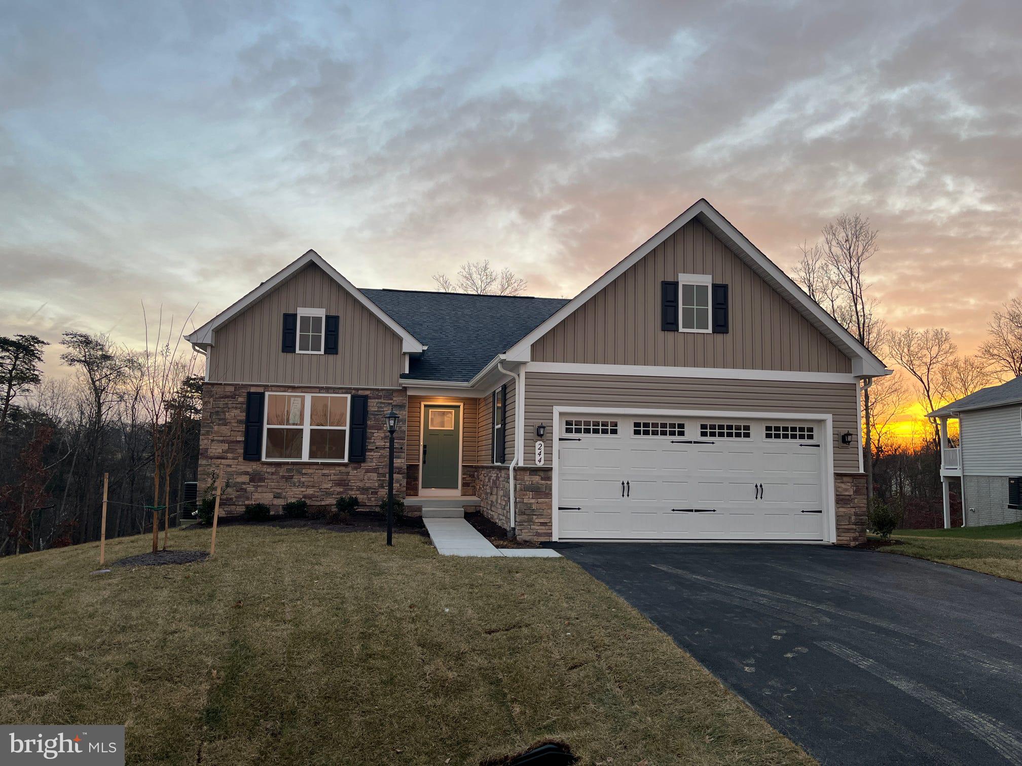 IMMEDIATE DELIVERY Gorgeous Eden Cay at  SOUTH BROOK Ranch Homes in Inwood, WV. The Eden Cay single-family floorplan makes main-level living easy. Step into the inviting foyer and find a versatile flex space which can be used as an office or 3rd bedroom. Another bedroom and full bath provide comfort and privacy for other family members or guests. The open plan includes an impressive great room, ideal for entertaining, and a gourmet kitchen with walk-in pantry. Gather round the expansive island or dining table for memorable meals.  The standard granite kitchen countertops, LVP flooring and beautifully tiled shower surrounds in the bathrooms make this a dream home.  LVP flooring has also been extended into your great room.  Step just outside your dining area onto the 10'X14' Covered Porch to enjoy the views and get some fresh air.  Your luxurious primary suite features double vanities and an extra wide walk-in closet. The 2-car garage Eden Cay is a can't miss, including an unfinished basement on a large, beautiful lot backing to trees.  The unfinished basement w/ walkout glass sliding door provides easy access to your back yard.  A 3-pc rough-in has been included for plumbing in case you'd like to finish a 3rd bathroom downstairs in the future.  The community features beautiful views, common areas and a dog park for homeowners to enjoy.  Convenient location w/ dining, shopping, schools and medical facilities within a 5 minute drive.