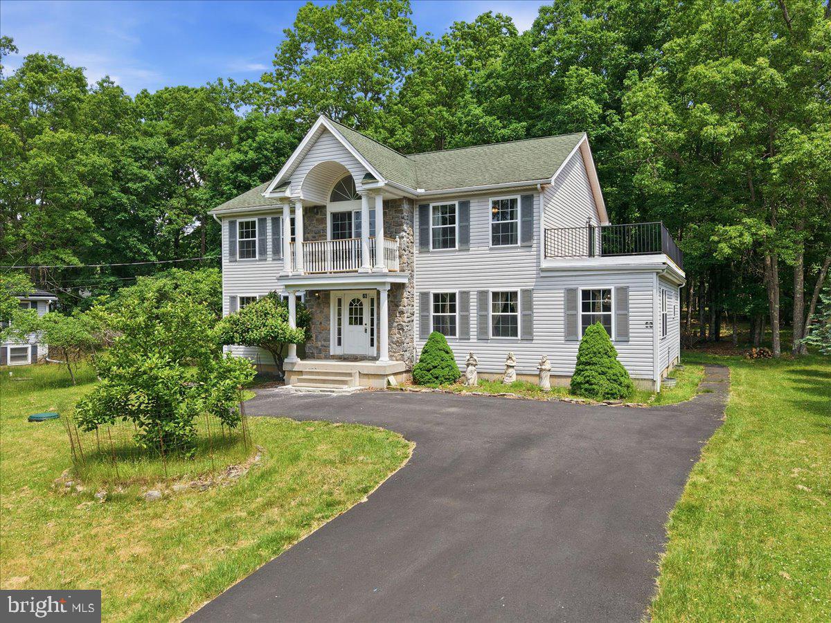 One Owner. Zero Compromises. Welcome to Indian Mountain Lakes From the moment you pull up, this stately colonial commands attention -- front pillars, pride-of-ownership curb appeal, and the quiet confidence of a home that has been genuinely cared for. Inside, the details only get better. Gleaming hardwood floors carry you through most of the main level, giving way to large-format 24x24 ceramic tile in the expansive kitchen and dining area. The kitchen itself is a showstopper -- massive in scale, appointed with rich custom cherry cabinetry, and bathed in gorgeous natural light pouring through generous windows. Dramatic luxury chandeliers punctuate the space with exactly the right amount of presence. Three full bathrooms serve three well-proportioned bedrooms, including a primary suite that earns the title. The walk-in closet is genuinely massive. The en-suite bath delivers a spa jetted soaking tub, a walk-in shower, double sinks, and tile floors -- a full retreat. Step through the primary bedroom doors onto your own private balcony overlooking the front yard, and the picture is complete. The second bedroom offers something equally coveted: access to a sweeping rooftop terrace -- a rare outdoor living bonus that opens up the sky and elevates every season. Central AC keeps things comfortable year-round, and updated PEX plumbing means the bones are solid. Downstairs, the massive unfinished basement, already sauna-equipped, is a blank canvas ready for whatever the next owner envisions. A back deck overlooks a shady, peaceful backyard that invites you to slow down. All of this sits inside the a gated STR-friendly HOA offering 3 lakes (1 fishing) 2 swimming pools and positioned for the Pocono lifestyle in every direction. Minutes to Route 715 and I-80. A short drive to Jack Frost/Big Boulder,Hickory Run State Park, paintball and UTV rentals -- and just 20 minutes to Pocono Raceway. A rare find in the Poconos -- one owner, beautifully kept, and ready for its next chapter