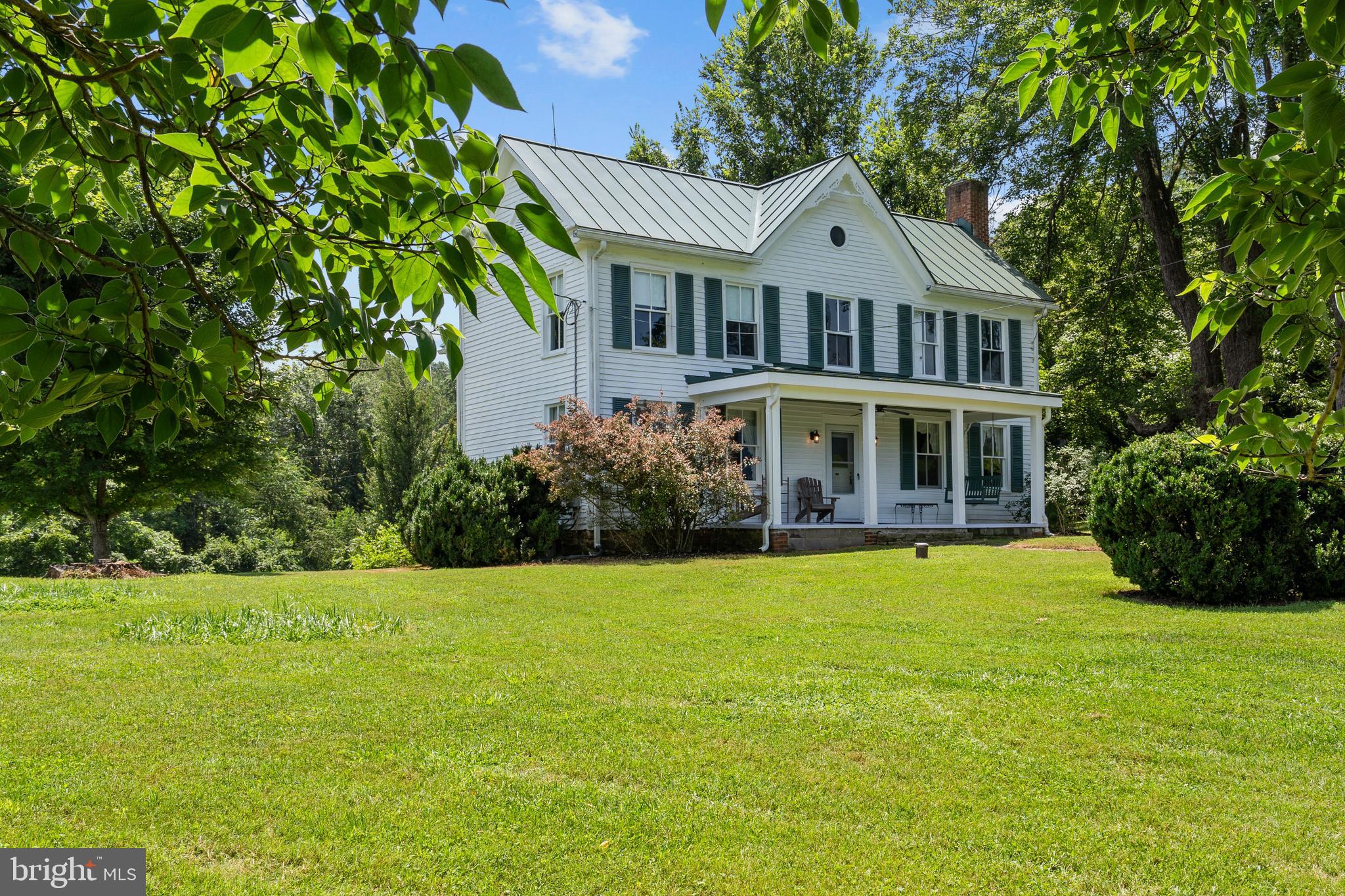 Step back in time with this charming 4 bedroom farmhouse on 30 acres of prime land.  Only minutes from Little Washington, Glendalough feels miles away.  The home is located on a small knoll with stunning views of the Shenandoah National Park.  On a dark evening, you can watch the headlights of the few cars that traverse the Skyline Drive.  Of course, the daytime views are pretty spectacular especially when you get the chance to watch a storm play along the mountains while you enjoy the sunshine.  The 4 bedroom home circa 1900 has been nicely updated to include a first floor primary bedroom with ensuite bath and ductless minisplits in most rooms to provide heating and cooling.  The home features a wide front porch to take in the views, a generous living room with a wood burning fireplace and fabulous dining room.  The country kitchen features a small dining nook and could be easily opened into the dining room for a more open floor plan.  The second floor features 3 more bedrooms and a bonus room replete with servant stairs that lead down to the kitchen.  The 30 acre property has a gentle roll as it leads up from the Rush River and is perfect for farming, horses & livestock or just plain enjoyment.  Several old barns are located next to the home and add a sense of timeliness and history.  Washington Virginia is the County Seat for Rappahannock County. It is a quintessential small mountain village with period homes, interesting shops, art galleries and several dinning destinations. It is home to the renowned Inn at Little Washington, one of the best inns and restaurants in the United States. Further afield in Rappahannock County is an array of wineries, interesting farms, art galleries, great eateries, breweries, a distillery and an entrance to the Shenandoah National Park.