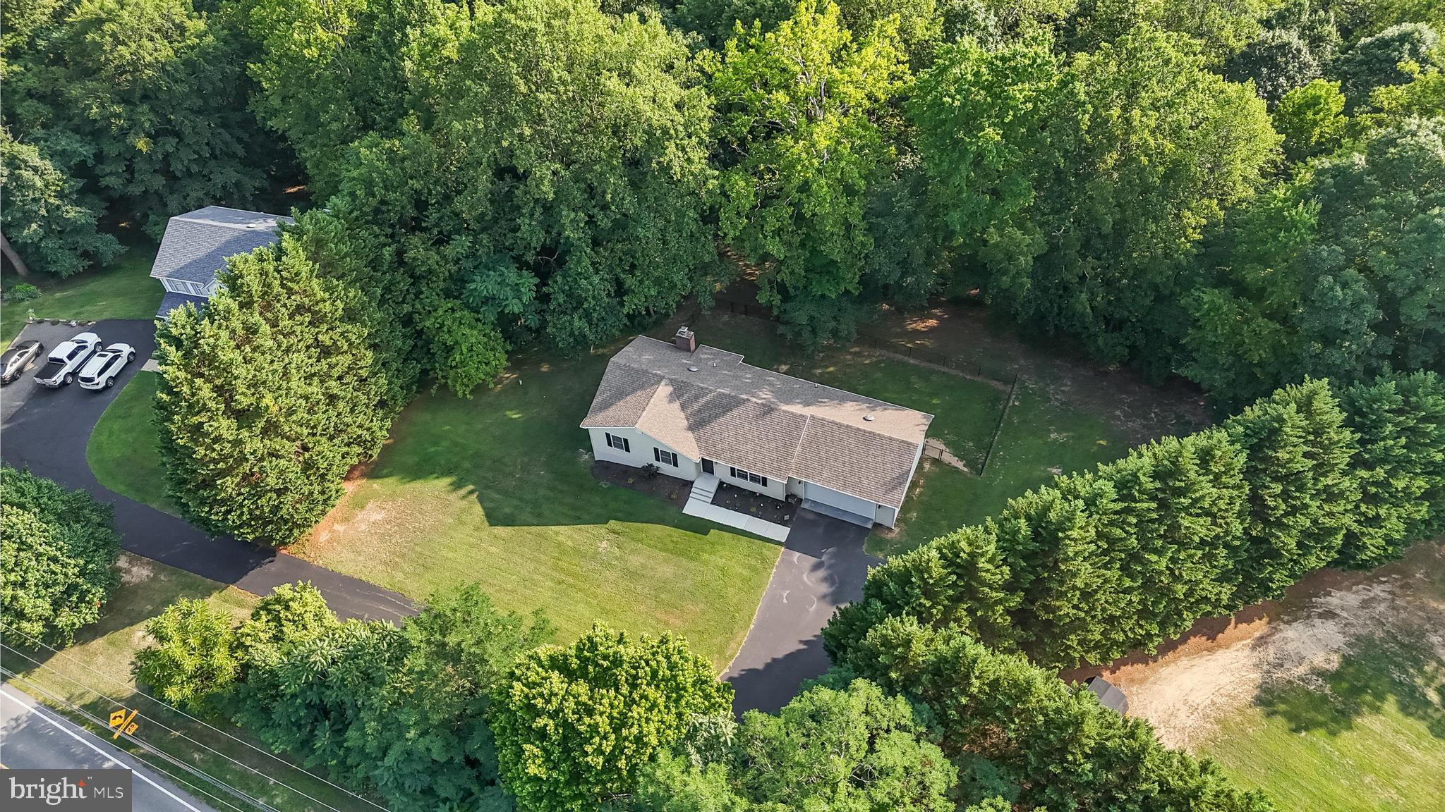 Welcome Home to this beautiful property set on over 4 private acres, offering the perfect balance of space, privacy, and the freedom of no HOA. Everything you need is here to move in and start living. Step inside to luxury vinyl flooring, a large living room filled with natural light, and a country kitchen with white custom cabinets, granite countertops, and stainless steel appliances—perfect for the chef in the family. Enjoy first-floor living with three bedrooms upstairs and two full baths. In the basement you will appreciate a very open floor plan, featuring a huge rec room, new pellet stove, an additional bedroom/flex area, and a full bath. The owners have thoughtfully upgraded in recent years, including extending and seal-coating the driveway, upgrading the basement floors, and upgrading the HVAC system. Outside, enjoy a peaceful setting with a newly fenced-in backyard, perfect for your fur family and summer BBQs. Lastly, this home boasts a large two-car garage ready for your cars, boats, or UTVs, or to become the ultimate workshop; act fast—this home won’t last!