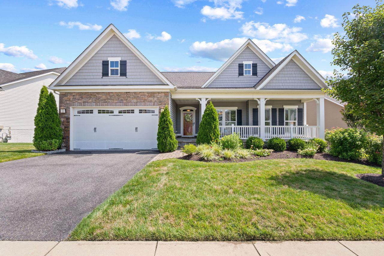 Built in 2016, this detached home showcases a harmonious blend of modern architecture and high-end finishes, ensuring a warm and inviting atmosphere. Step inside to discover a spacious layout that features four generously sized bedrooms and four beautifully appointed bathrooms. The heart of the home is the gourmet kitchen, complete with upgraded countertops, an island for casual dining, and a pantry that caters to all your culinary needs. The combination of the kitchen, dining, and living areas creates an ideal space for entertaining or enjoying quiet evenings at home. Crown moldings and wainscoting add a touch of sophistication, while recessed lighting and ceiling fans enhance the ambiance throughout. The family room, conveniently located off the kitchen, is perfect for gatherings, and the formal dining room provides an elegant setting for special occasions. The gas fireplace is double-sided, both the focal point of the family room and creating a cozy space on the elevated screened porch. The primary suite is a true retreat, featuring a luxurious bathroom with a walk-in shower, dual sinks with granite vanities, and plenty of walk-in closet space. Additional highlights include hardwood and ceramic tile flooring, and a main floor laundry for added convenience. An upper level bedroom and bath may also be a useful office space. The lower level bedroom and bath offers guests additional privacy. The basement family room includes a bar for entertaining, and the basement French doors open to a lovely paver patio, to continue the party outside. Outside, the property boasts extensive hardscaping and exterior lighting, creating an inviting outdoor space for relaxation or entertaining. Enjoy the lush garden and lawn views from your backyard, perfect for unwinding after a long day. The community amenities are second to none, featuring an outdoor and indoor pool, tennis courts, a clubhouse, and a recreation facility that encourages an active lifestyle. With walking and biking trails, a dog park, and various recreational options, there's always something to do. Parking is a breeze with an attached two-car garage, providing both convenience and security. The community association takes care of common area maintenance, lawn care, and management, allowing you to focus on enjoying your new home and the vibrant lifestyle it offers. This property is not just a home; it's a gateway to a fulfilling and luxurious lifestyle in a welcoming community. Experience the perfect blend of comfort, elegance, and convenience in this exceptional residence.