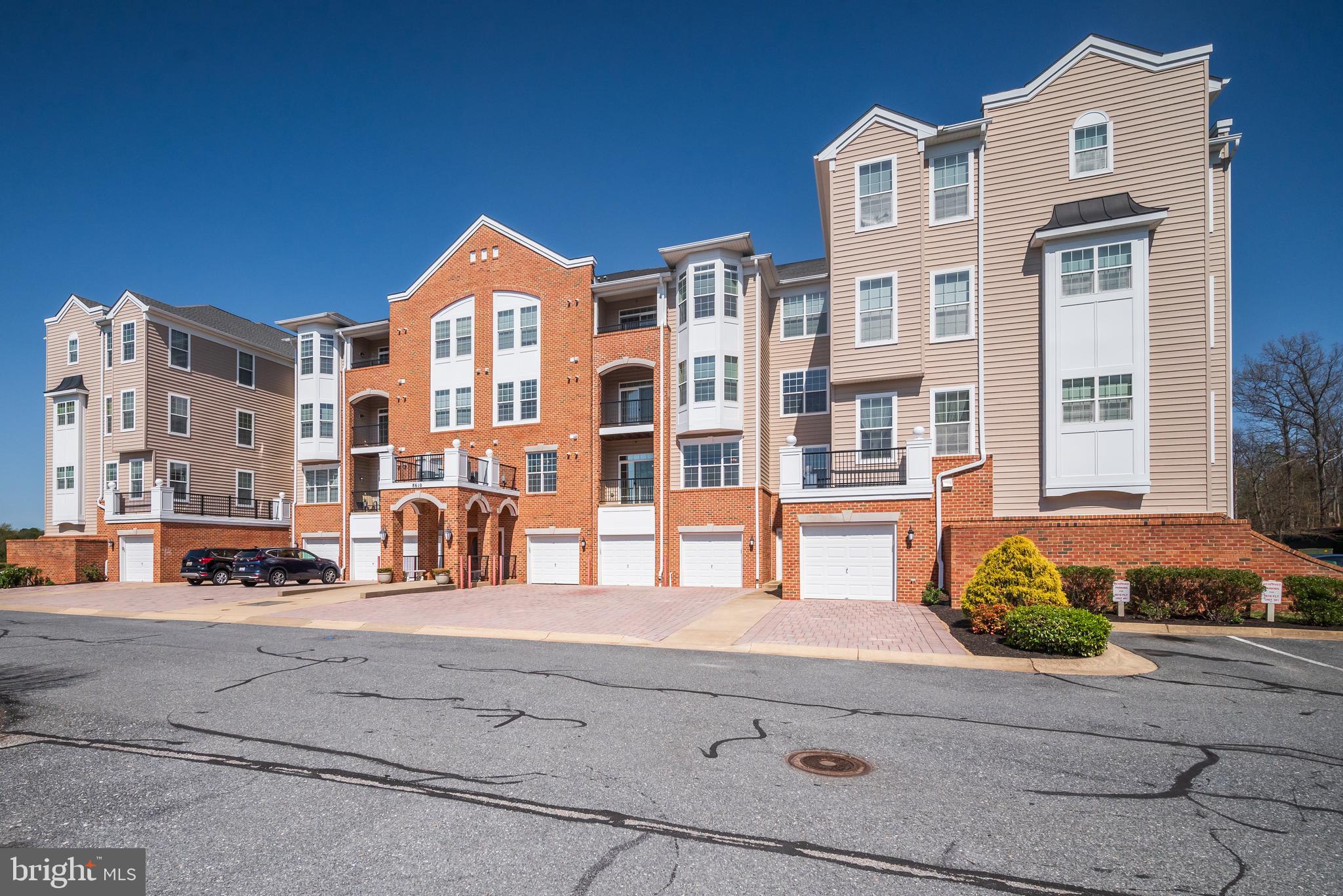 First time presented by original owner. Beautifully maintained and thoughtfully designed condo in elevator building is perfectly sited  in this 55 and better community.  Streaming with natural light and abundant storage, this unit is sure to please. Large living/dining room combo  features crown molding, tray ceilings and access to private balcony. Kitchen offers 42" cabinets, some with glass fronts, pantry, French door refrigerator w/ice and filtered water on the door, double sink and serving counter which opens to the living and dining area. Primary suite  features tray ceilings with ceiling fan, separate sitting area with bump out bay & ceiling fan, cavernous walk-in closet plus separate closet. Spacious primary bath with double sinks, shower  enclosure and linen closet. Guest bedroom with  ceiling fan , walk-in closet plus two other storage spaces, access to hall bath with tub shower and large vanity. Dedicated laundry room with extra cabinets and storage shelves.  Don't miss the separate office/den space for added functionality. . Unit is ideally located in close proximity to the elevator and offers its own private garage plus reserved parking. Building is  conveniently located to both the on site fitness center/pool and the shopping plaza providing for all your day to day needs and your entertainment cheer. Freshly painted with new carpet throughout, this unit is move-in ready. Welcome home!