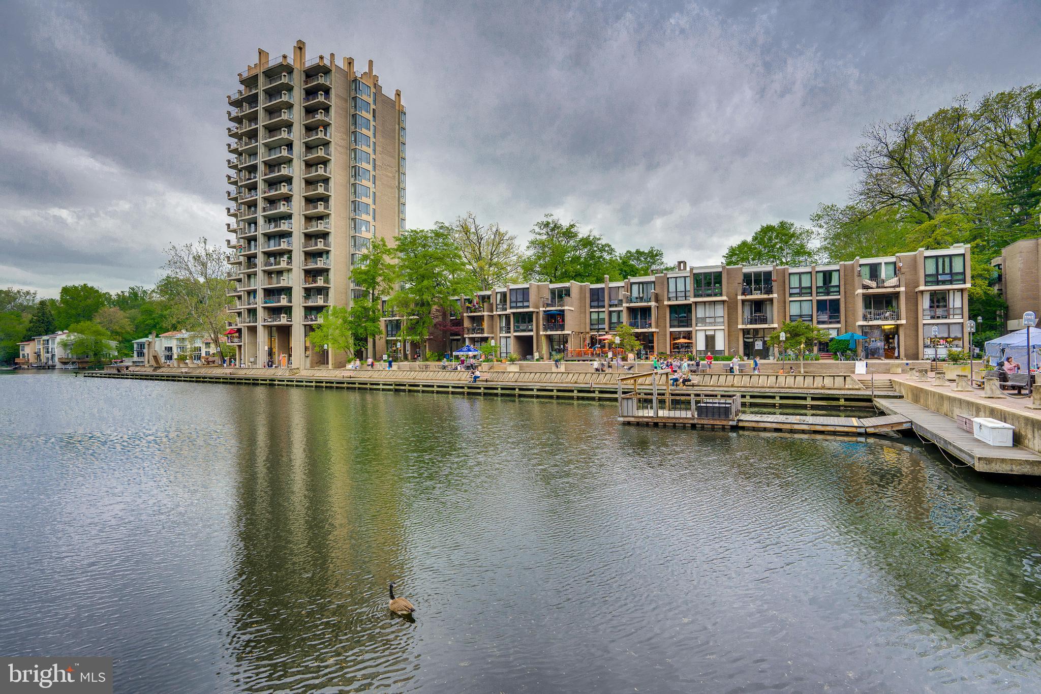Charming 1 BR/ 1 Bath condo located in Reston's original Village Center.  Enjoy all that this amazing neighborhood has to offer. The Saturday Farmer's & Craft Market,  Free Summer Concerts,  ceramic classes at the Reston Community Center; meet friends for a beer at the Lake Anne Brew House or grab some dinner on the Plaza.  Take a walk around Lake Anne, or sit on your balcony overlooking the lake and enjoy the breeze.  If you love Mid-Century Modern you'll love the original details of this condo-- and you'll love this building.  Just 4 units per floor, these thoughtfully designed spaces are private and quiet. Honestly, this is a special place to live! Condo fee includes ALL UTILITIES and Cable TV!
