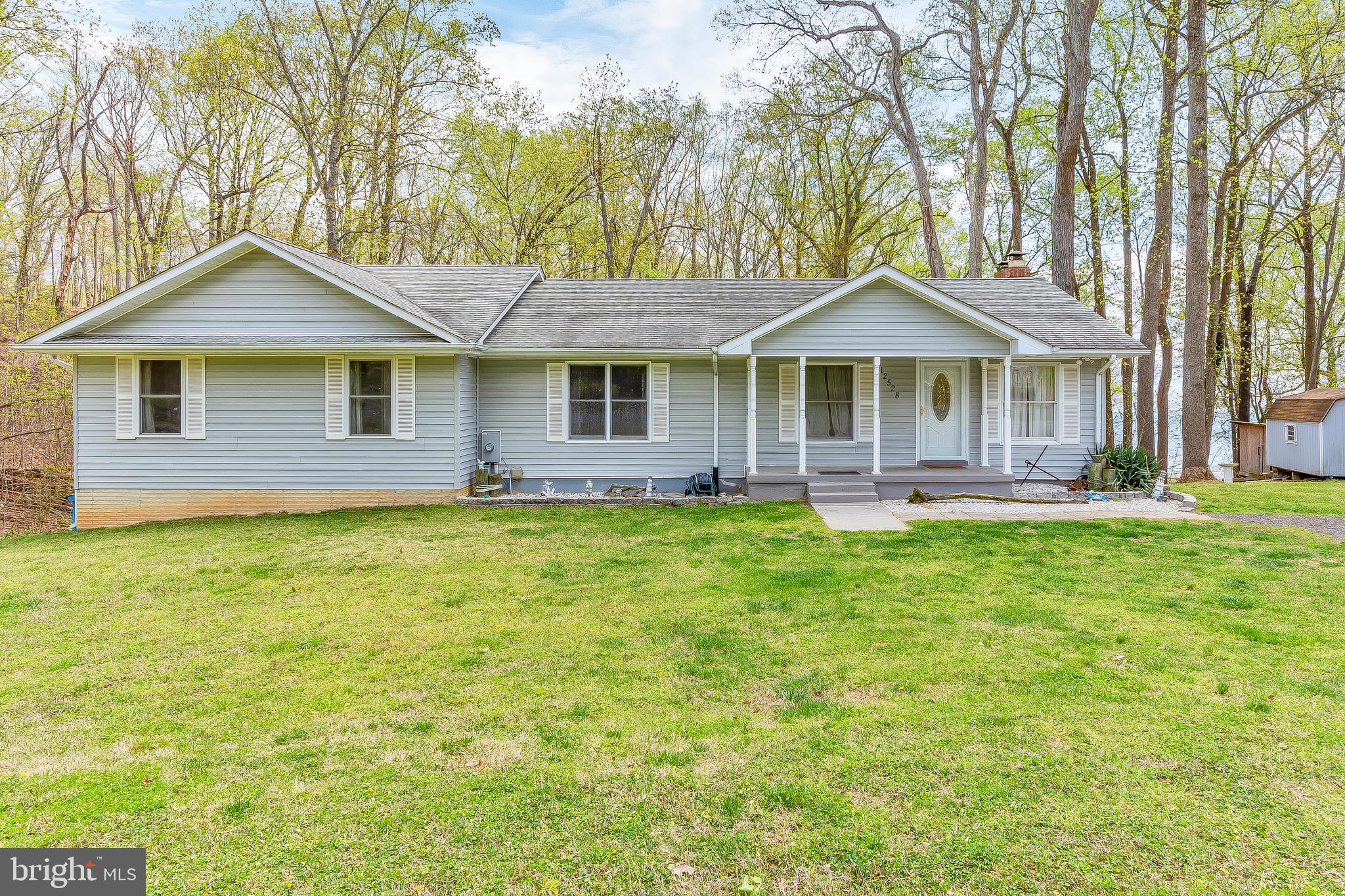 WATERFRONT!! This awesome 3 Bed 3 Bath Rambler backs to a parcel that is considered part of the Chesapeake Bay making it waterfront! Not only are the views phenomenal, but there is a path in the rear which allows a handful of adjoining properties access to an amazing private beach/lagoon area! The .88 Acre lot provides tremendous privacy!! Upon entry you enjoy the open concept that leads to a massive back deck to take in the views of the bay! Down the hall you will find the hall bathroom, laundry room, guest bedroom and enormous master suite! The master suite is so large that another bedroom could be easily split off of it and a large master would still be obtainable!! In addition to sheer size this master boasts his/her closets, bay views, access to the rear deck and a large en-suite bath! In the basement you will  find family room with a woods stove,  the 3rd bedroom, a full bathroom, & a pub like bar area. The bar area is equipped with a fridge, freezer, microwave, sink and plenty of space for entertaining! The basement walks out to the backyard in two locations providing easy access to the hot tub, koi pond, and walkway to your very own private beach! This is truly bay front living with the price tag. Don't miss out on this rare find!