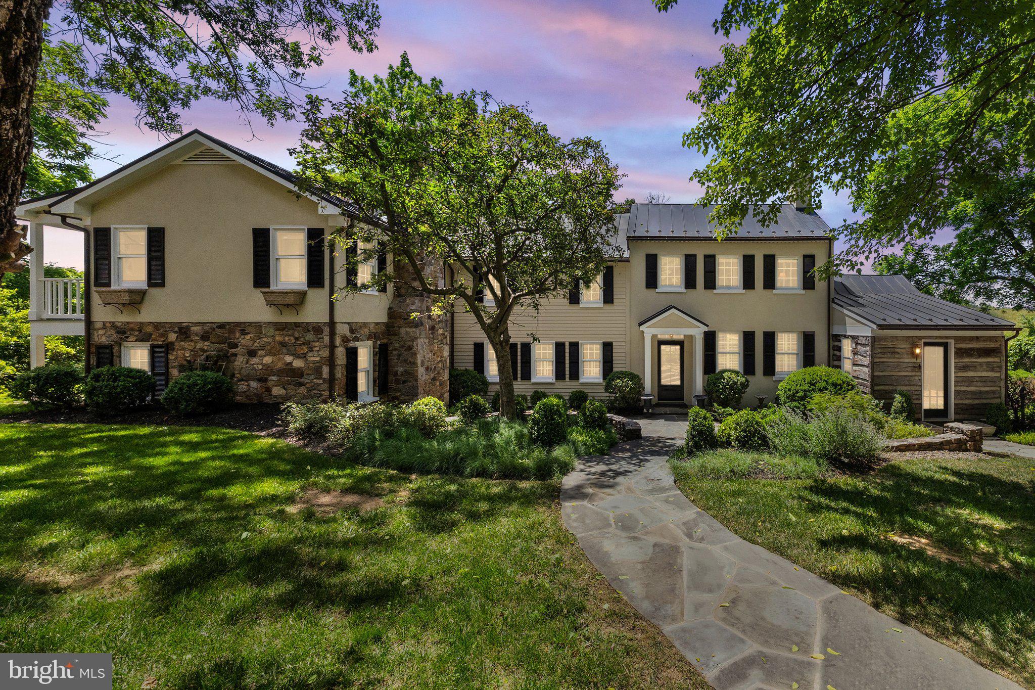 NEW PRICE!!!  Welcome to 21056 Beaverdam Bridge Rd., Middleburg, VA 20117—where historic charm meets modern luxury in a peaceful and secluded setting. Affectionately known as “Turkey Roost Farm” or simply “The Roost” by locals, this circa 1750s farmhouse offers a storybook escape nestled in the heart of Middleburg’s picturesque countryside. The interior has been thoughtfully updated to blend old-world character with today’s comforts. At the heart of the home is a gourmet chef’s kitchen featuring a Viking cooktop, soapstone counters, a custom wood island with storage, and stainless-steel appliances—perfect for both everyday living and entertaining.

This charming residence offers 4 bedrooms and 3.5 baths, including a luxurious primary suite complete with a soaking tub and spacious shower. Gather around the wood-burning fireplaces in the cozy family room and the original stone fireplace in the living room or unwind on the upper-level balcony and side yard porch. The expansive flagstone rear patio—partially covered and enhanced with skylights—invites effortless outdoor living and entertaining.

Additional features include solid hardwood flooring throughout, dual staircases, and a two-car garage with a studio loft above. A separate one-bedroom, one-bathroom cottage with an efficiency kitchen provides a perfect retreat for guests or extended family. Equestrian amenities abound with a five-stall barn equipped with automatic waterers, fenced paddocks with run-in sheds, a blue stone riding ring, and scenic trails for exploration. The property also boasts a spring house, custom chicken coop and pen, all adding to its rural charm and functionality.

Located just minutes from historic downtown Middleburg, this one-of-a-kind property offers convenient access to shopping, dining, and cultural attractions, with an easy commute to Northern Virginia, Washington, D.C., and just 25 miles from Dulles International Airport. Turkey Roost Farm is a rare opportunity to own a timeless retreat that offers both serenity and sophistication.