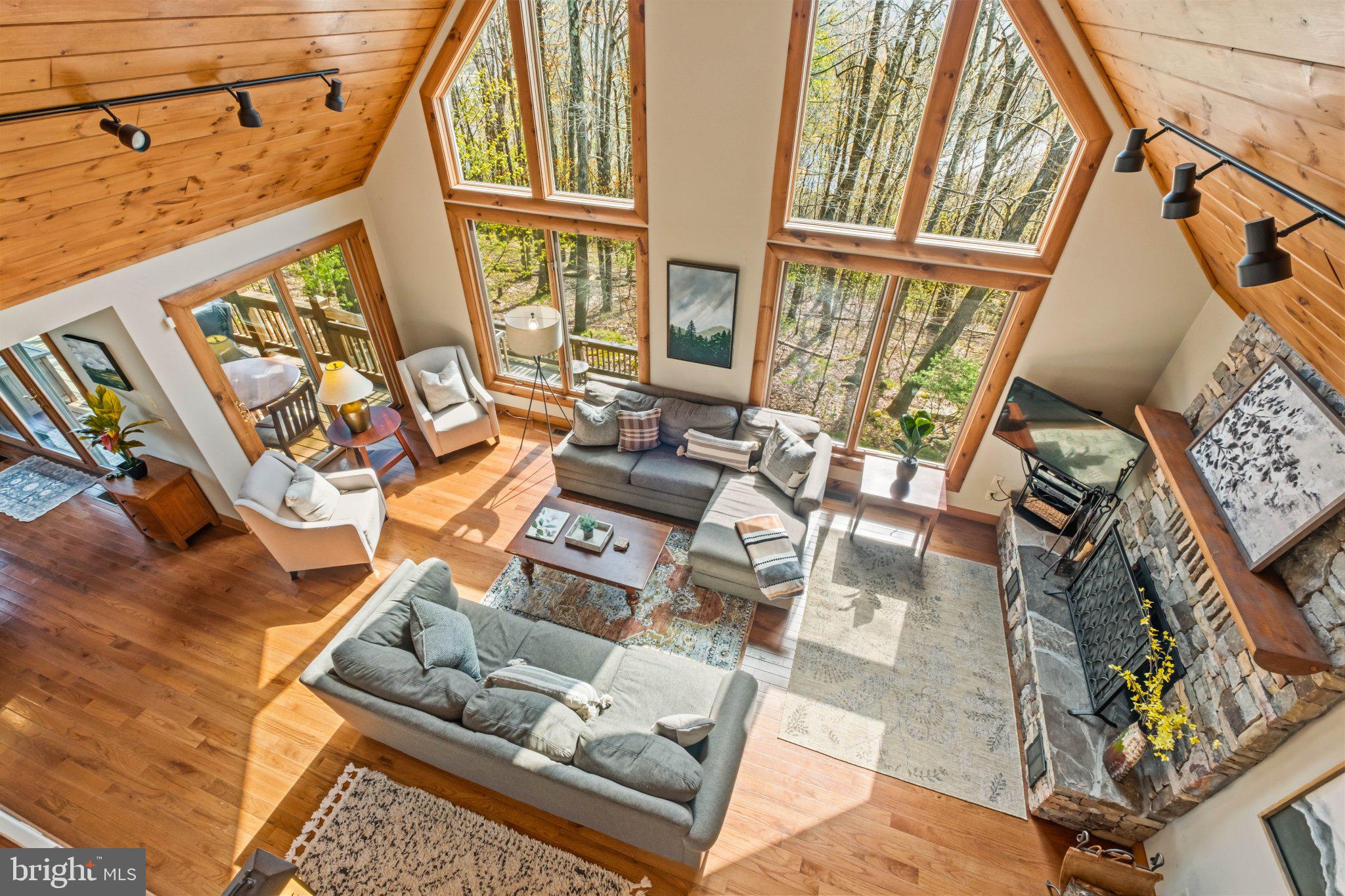 Experience mountain living at its finest in this stunning 5-bedroom, 6-bath retreat nestled directly on the slopes of Wisp Resort with breathtaking views of Deep Creek Lake. Designed for those who love skiing, nature, and luxury mountain escapes, this exceptional home offers over 4,000 square feet of beautifully designed living space.  
The open-concept layout is filled with natural light, creating a warm and inviting atmosphere perfect for gathering with family and friends after a day on the slopes. Enjoy peaceful mornings and unforgettable sunsets from two expansive levels of decks surrounded by the beauty of Garrett County.
With plenty of room to spread out, this home is ideal as a second home, a vacation property or your full time home. Conveniently located just minutes from Deep Creek Lake, Lodestone Golf Course, local dining, hiking trails, and year-round outdoor recreation, this property offers the ultimate four-season mountain lifestyle.

This is an established rental called "One Ski Hill".

Please note, this is a TRUE ski in/ski out home. There are 10 steps from the deck to the slopes.  
Also Roger Sines is the builder.    He is a coveted builder at Deep Creek Lake.   
Also, the land south of the house will never be developed.