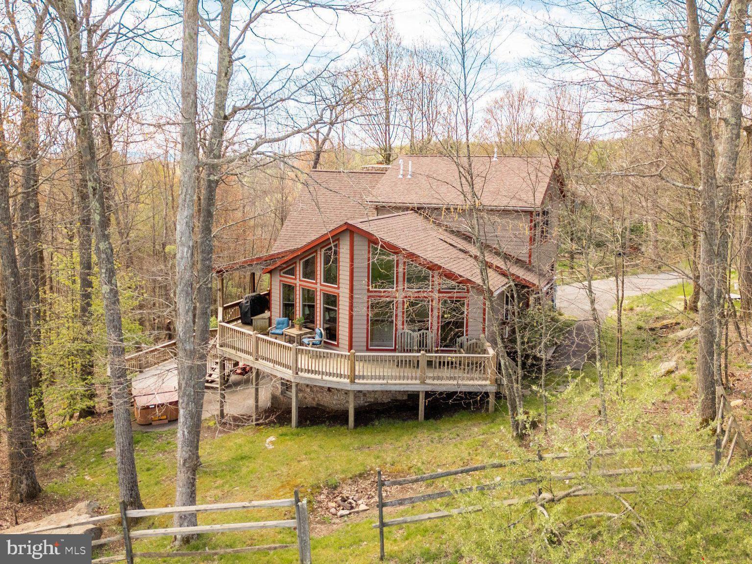 Experience mountain living at its finest in this stunning 5-bedroom, 6-bath retreat nestled directly on the slopes of Wisp Resort with breathtaking views of Deep Creek Lake. Designed for those who love skiing, nature, and luxury mountain escapes, this exceptional home offers over 4,000 square feet of beautifully designed living space.  
The open-concept layout is filled with natural light, creating a warm and inviting atmosphere perfect for gathering with family and friends after a day on the slopes. Enjoy peaceful mornings and unforgettable sunsets from two expansive levels of decks surrounded by the beauty of Garrett County.
With plenty of room to spread out, this home is ideal as a second home, a vacation property or your full time home. Conveniently located just minutes from Deep Creek Lake, Lodestone Golf Course, local dining, hiking trails, and year-round outdoor recreation, this property offers the ultimate four-season mountain lifestyle.

This is an established rental called "One Ski Hill".

Please note, this is a TRUE ski in/ski out home. There are 10 steps from the deck to the slopes.  
Also Roger Sines is the builder.    He is a coveted builder at Deep Creek Lake.   
Also, the land south of the house will never be developed.