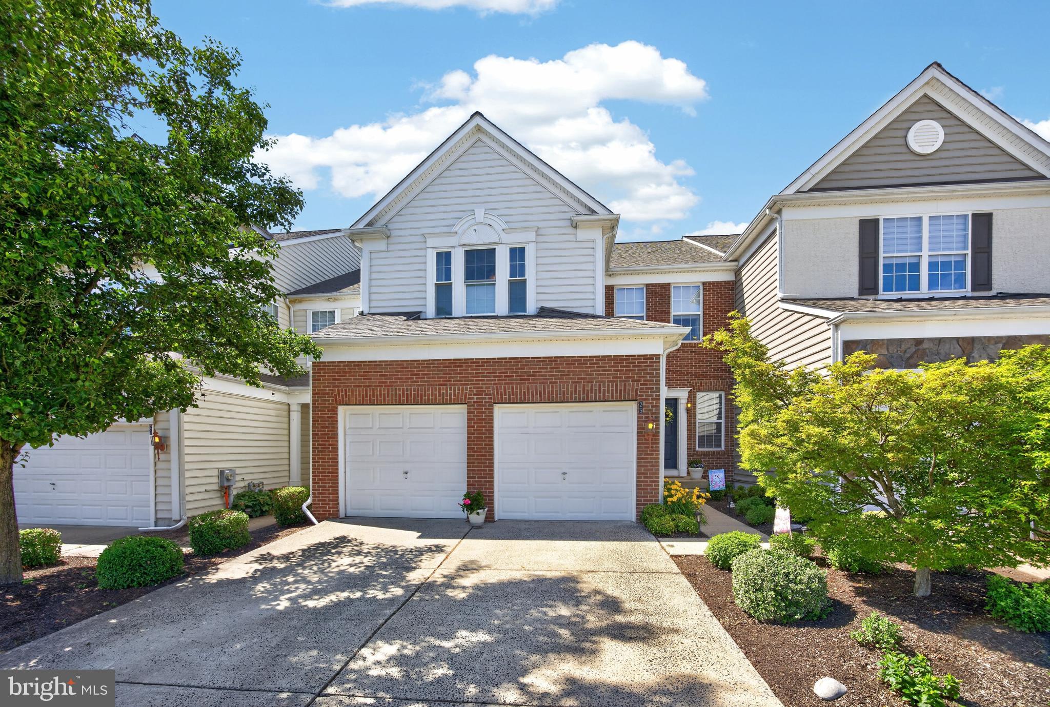 Welcome to this elegant and impeccably maintained brick-front, interior carriage home in the desirable Longford Crossing community of Upper Providence Township. Built by Pulte and enhanced with timeless architectural details, this beautiful 3-bedroom, 2.5-bath home offers the perfect blend of sophistication, comfort, and functionality. From the moment you enter, you'll appreciate the extensive wainscoting, crown molding, architectural columns,  and natural light that create a warm and inviting atmosphere throughout. The main level is designed for both everyday living and entertainment. The entry foyer leads to the formal dining room, highlighted by a tray ceiling, making it an ideal space for hosting holiday dinners and special gatherings. The spacious living room features a corner gas fireplace with elegant picture-frame molding above, creating a beautiful focal point for relaxing evenings at home. The adjacent eat-in kitchen and morning room offer picturesque views of the wooded backdrop and provide the perfect setting for casual meals, morning coffee, or gathering with friends. The kitchen features stainless steel appliances, wood cabinetry, Corian countertops, a decorative tile backsplash, and an oversized center island that serves as both a workspace and gathering spot. Sliding doors lead to a private deck overlooking mature trees, offering a peaceful outdoor retreat and one of the sellers' favorite features of the home. A convenient laundry room and powder room complete the first floor. Upstairs, the spacious primary suite serves as a true sanctuary, featuring a tray ceiling, a generous sitting area ideal for a reading space, home office, or private retreat, a walk-in closet, and an en-suite bath with a soaking tub, separate shower, 12" x 12" tile flooring, and double-bowl vanity. Two additional generously sized bedrooms, each with ceiling fans, share the hall bath. Tasteful neutral decor, recessed lighting, and plenty of natural light continue throughout the upper level. The full basement offers exceptional potential for future living space, whether you envision a recreation room, home gym, media room, or playroom. With rough-in plumbing already in place for an additional full bath, the possibilities are endless. Additional highlights include a two-car garage, private driveway parking, and convenient overflow parking located directly in front of the home. Ideally situated, Longford Crossing offers easy access to the vibrant dining, shopping, and entertainment destinations of Phoenixville and King of Prussia, as well as the popular Providence Town Center. Outdoor enthusiasts will appreciate the many nearby parks, walking and biking trails, and recreational opportunities, including access to the scenic Schuylkill River Trail and Valley Forge area trails. Combining elegant design, exceptional care, beautiful, wooded views, and a prime location, this remarkable home offers a lifestyle that is truly second to none.