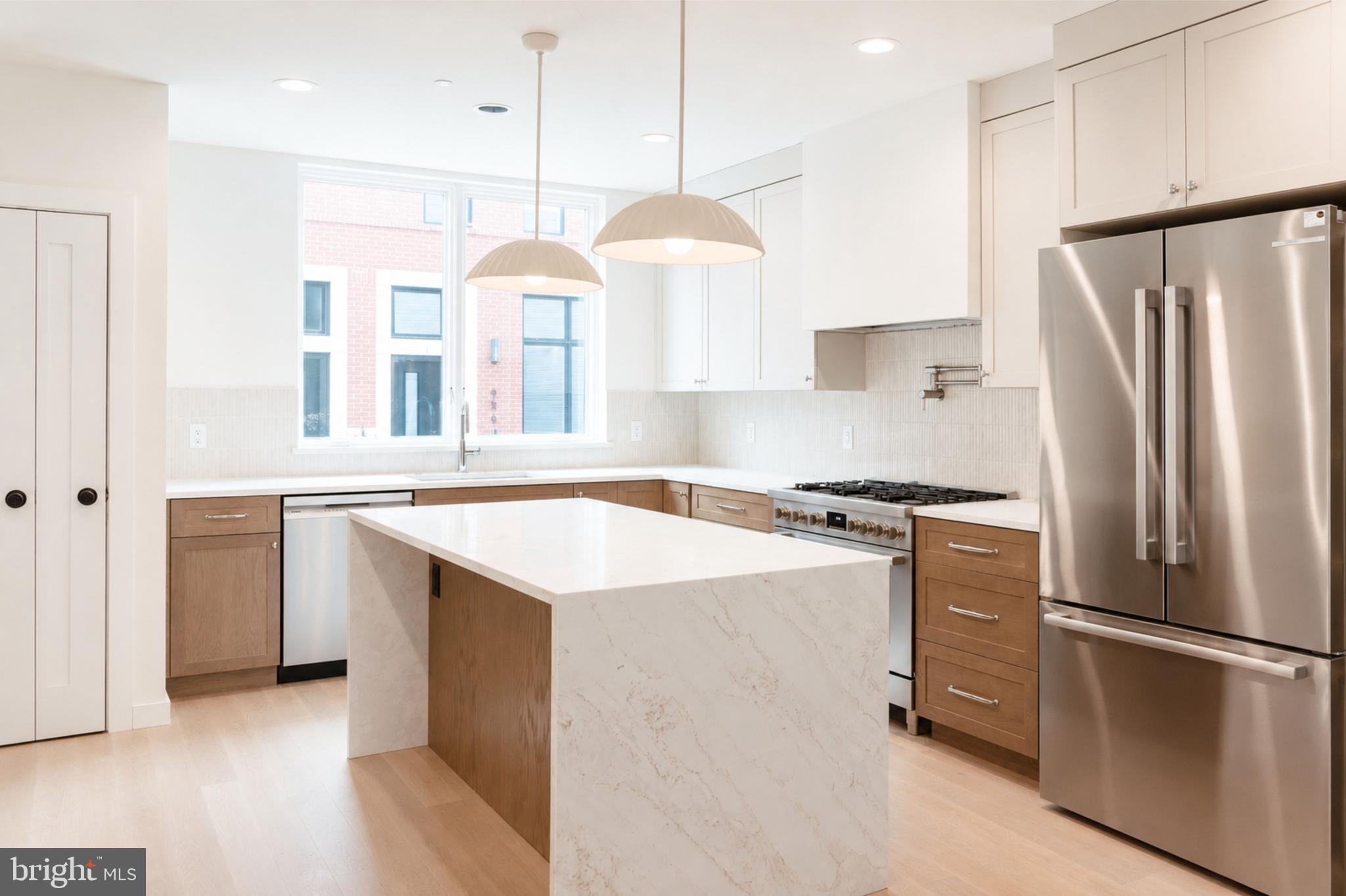 Welcome to Wendle Place Phase 4—a rare opportunity to own a brand-new home in one of Philadelphia's most sought-after new construction communities, this time with FOUR different finish packages to choose from. Photos shown include examples of the four available finish packages and may depict features, colors, and selections from different homes within the community. Backed by an experienced development team and a curated palette of premium materials, every residence is built with design integrity from the ground up. Phase 4 residences offer the same premium layout as Phases 1 & 2, featuring a dramatic split-level living area with soaring ceiling heights, 3 bedrooms, 3 full baths, 2 half baths, 2-car garage parking, multiple outdoor spaces, and a private rooftop deck with green roof. Every home includes the full 10-Year Tax Abatement and a 1-Year Builder's Warranty. Nestled along the beautifully tree-lined 6th Street in the heart of Northern Liberties, Wendle Place sits just steps from some of the neighborhood's most iconic destinations—Bardot Café, Café La Maude, and Liberties Walk—offering unmatched access to dining, shopping, bike trails, and public transit. Developed by Catalyst City Development and designed by Gnome Architects, the project seamlessly blends modern design with timeless craftsmanship. Ask about our financing options with preferred lender.*
