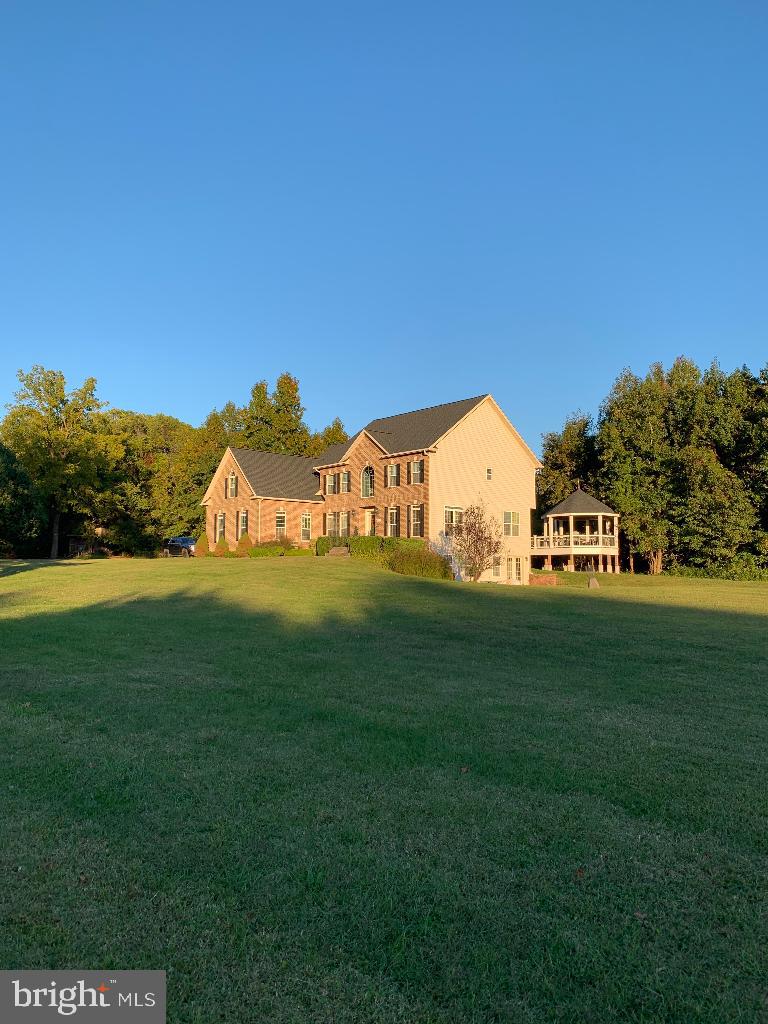 Turn Key dog boarding facility (24 runs) on property! Five horse paddocks with two run-in sheds and small barn. 21 acres with fields, woods, large pond with beautiful stone waterfall. New roof, gutters, shutters: Spring 2022 New hardwood flooring 2nd floor and one staircase Fall 2022 New HVAC unit and furnace, 2022; 2nd HVAC unit replaced 2021 Kennel HVAC unit replaced 2020 New 75 gal hot water heater 3/2024 New Maytag washer and dryer in kennel 5/2024 House septic and kennel septic pumped 5/2024 New professionally designed closets for all four bedrooms, including 23' primary closet. New and HUGE Trex deck with gazebo overlooking fields. All new paint and fixtures throughout! Ceramic tile and hardwood flooring throughout, no carpet. Basement has new kitchen with full-size stainless steel appliances and granite countertops, new stacking washer/dryer, full bathroom, walkout/slider, ceramic tile flooring. Work from home...operate boarding kennel, board horses, potential for wedding venue Please note: boarding kennel is currently in operation and accepting reservations throughout the year.