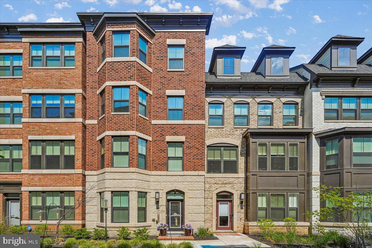PRICE IMPROVEMENT!  This gorgeous home has just become  even more desirable with a  large price reduction!  Imagine stepping outside your door and strolling just half a block to the W&OD trail for a morning walk or evening bike ride, then grabbing coffee or dinner at one of the many nearby restaurants.  Whole Foods, boutique shops on Church Street, the Post Office, a brand-new public library (coming soon), and the town's Community  Center are all within a short  walkable distance.  Built in 2021, the home offers nealy 2700 square of thoughtfully designed  luxury, with bay windows,  plantation shutters, crown mouldings, 2-zone HVAC system for temperature comfort, 6 Casablanca ceiling fans, 3 large screen tv sets installed on 3 levels, epoxy-sealed 2-car garage, with extra storage space, a gourmet kitchen with beautiful quartz countertops, and a a covered balcony with a gas fireplace set in a gorgeous stone masonry.  The cherry on the cake is brought by a spacious rooftop terrace, on which to watch sunsets,  entertain guests.  or grow your own vegetables!  The Owner has put over $150,000 into luxury  improvements,  including a $20,000 jacuzzi walk-in bathtub on Lower Level, wood shelving built-ins on Main Level, custom-built walk-in closets in Upper Level bedrooms, plantation shutters and custom shades on all windows,  and  recessed lighting on all levels.  The Lower level space with a bay window,  can serve multiple purposes:  an office, a spare bedroom,  or a play area, while the top levels offer good size bedrooms each with en-suite bath, and a conveniently located laundry. The Main Level , flooded with light , presents an open Family/Kitchen/Dining  combo, which stretches  into an enclosed balcony with a charming gas fireplace  for relaxing or eating al-fresco.   The street is pedestrian-traffic  only, with built-in garages in the back, while the home facades are adorned with creative landscaping.  You will find convenient additional parking  in the back. The town delights in many outdoor events: Viva Vienna, Taste of Vienna, Harvest Festival, outdoor summer concerts and a Halloween Parade.   Open-air Wolf Trap  Performing Arts Center offers many cultural events in summer.  while beatiful Meadowlark Botanical Gardens delights visitors throughout the year.   Multiple cafes, restaurants pubs and bars, create perfect venues for indoor socializing.  Convenient public transportation includes Vienna /GMU Metro station,  buses, the Dulles airport,  and a short 15 miles commute to Washington DC.  Tysons shopping malls are just 2 miles away.  Fairfax County Public schools:  Louise Archer elem., Thoreau Middle, and Madison HS, are all high-ranking,  while a variety of art , music ,  dance,  and marshall arts classes are thriving in town.   The Market Square enclave, with its charm and tranquility, presents  best  value in Vienna luxury real estate!  The home is perfectly move-in ready and available for a quick possession.  List of improvements available in listing documents.  Open House Sunday 5/30, 2-4