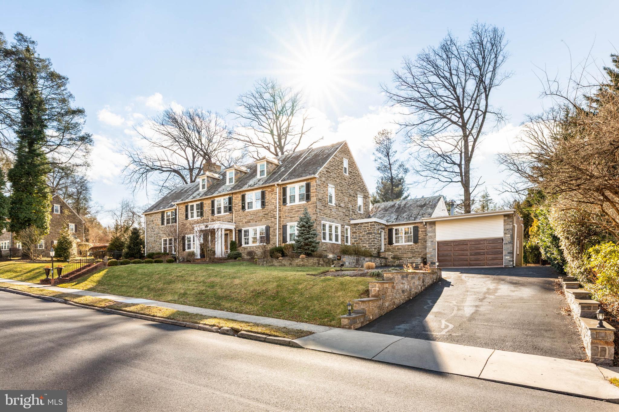 Elegance and classic lines define this beautiful Noble Road home in Rydal. Spectacular solid stone Colonial offers the rare combination of old-world craftsmanship, gracious scale, and suburban privacy.

Classic center-hall entrance introduces interiors defined by generous proportions, thoughtful architectural detail, and an effortless flow for both daily living and elegant entertaining. Original stonework, solid wood doors, stained glass accents, and polished hardwood floors reflect the integrity of the home’s inter-war construction, while a series of tasteful updates—including fresh neutral finishes and a beautifully renovated kitchen- new in 2024- bring the home seamlessly into the present while maintaining it’s period character. 

The formal living room, anchored by a stone fireplace, offers a refined yet inviting setting, the sunken family room is bathed in natural light with soaring ceilings, custom built-ins, and ample space for relaxed gathering.

One of the home’s most distinctive features is a custom architect-designed 2-story library and office, complete with elegant built-in bookcases, integrated workspaces, and a striking handcrafted spiral wood staircase—an intentionally designed space equally suited for professional use or inspired personal retreat, work from home area or creative space.

The hub of the home is the kitchen (2024) thoughtfully designed and updated for both function and connection, opening to a bright breakfast area featuring beautiful cabinetry and higher end appliances. The kitchen flows naturally into the family room and outdoor entertaining spaces.

Outdoors, the property reveals a cinematic glamour: a secluded setting featuring an in-ground pool and spa, gazebo, flagstone patio, and manicured well-maintained grounds that invite lingering afternoons and memorable evenings. Privacy, scale, and atmosphere converge here—an exceptional suburban escape.

The home offers five bedrooms and four and a half baths, including a serene primary suite and additional flexible spaces ideal for family, guests, or au-pair accommodations. A finished lower level adds versatility with additional living areas and a full bath.

Many updates since 2021: Attractive hardscaping, new pool filter, pool resurfaced, new pool edging and hot tub configuration, new pool fencing, 18 new windows, extensive exterior landscaping, LR chimney and firebox rebuilt. Please see sellers property disclosure for additional items including HVAC & Bathroom updates.

Ideally positioned home within 30 minutes of Center City Philadelphia- with easy proximity to hospitals, medical centers, universities and many major corporate headquarters,  Blue Ribbon Abington Township schools and easy private school commutes.

This Rydal residence offers space to grow, room to breathe, and a setting to stay. It provides a rare opportunity to acquire a legacy property that has also been thoughtfully updated and maintained.  Exterior photos of the pool open "in season" are lower resolution but illustrate well the updated condition of the pool and entire pool area.