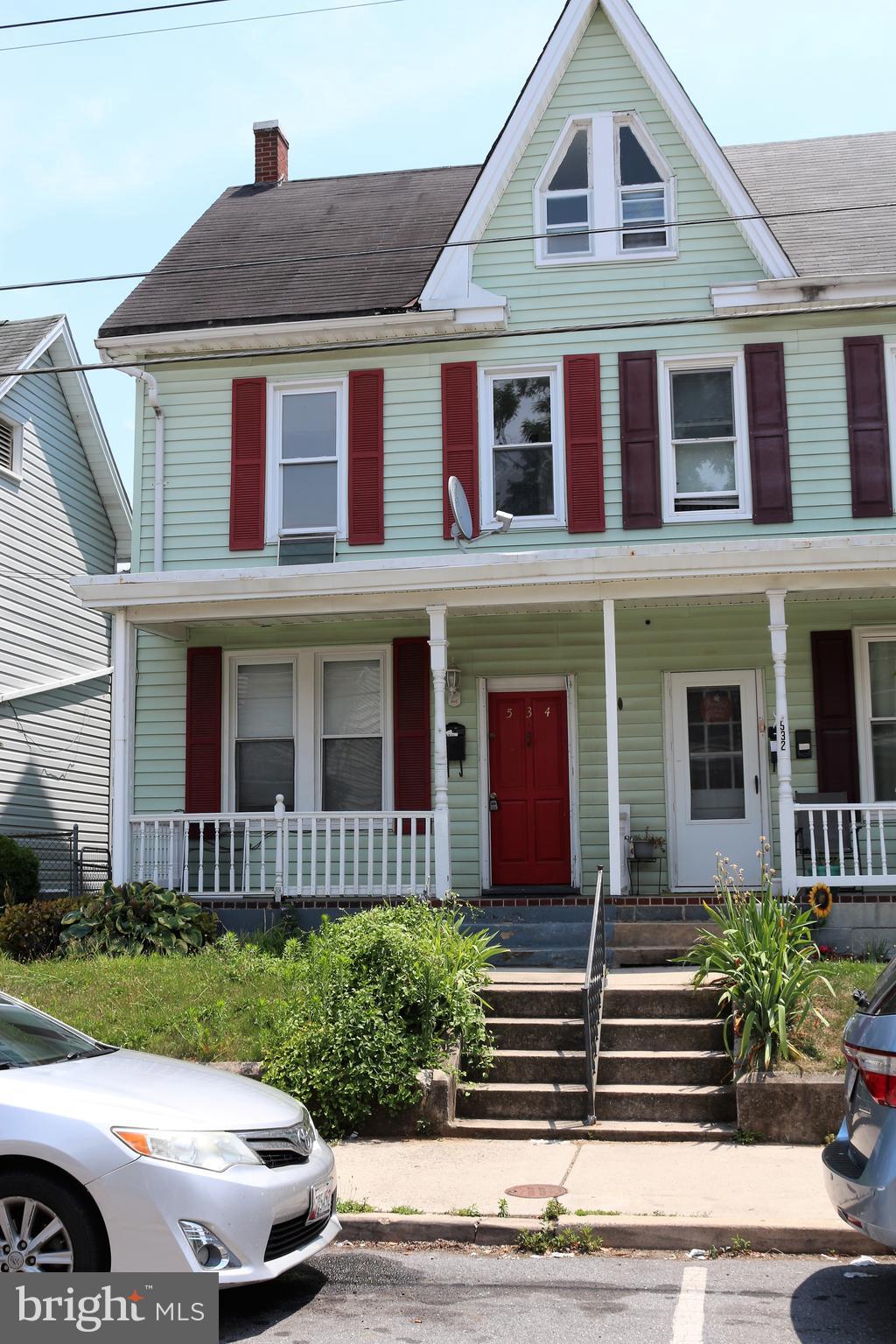 Nice half duplex with 3 bedrooms and finished walk-up attic area for additional living space.  Main level offers updated kitchen, living room, dining room with wood floors, full bath and laundry room.  Upper level offers 3 bedrooms and hall bath.  Parking in rear off alley.  Easy to show!