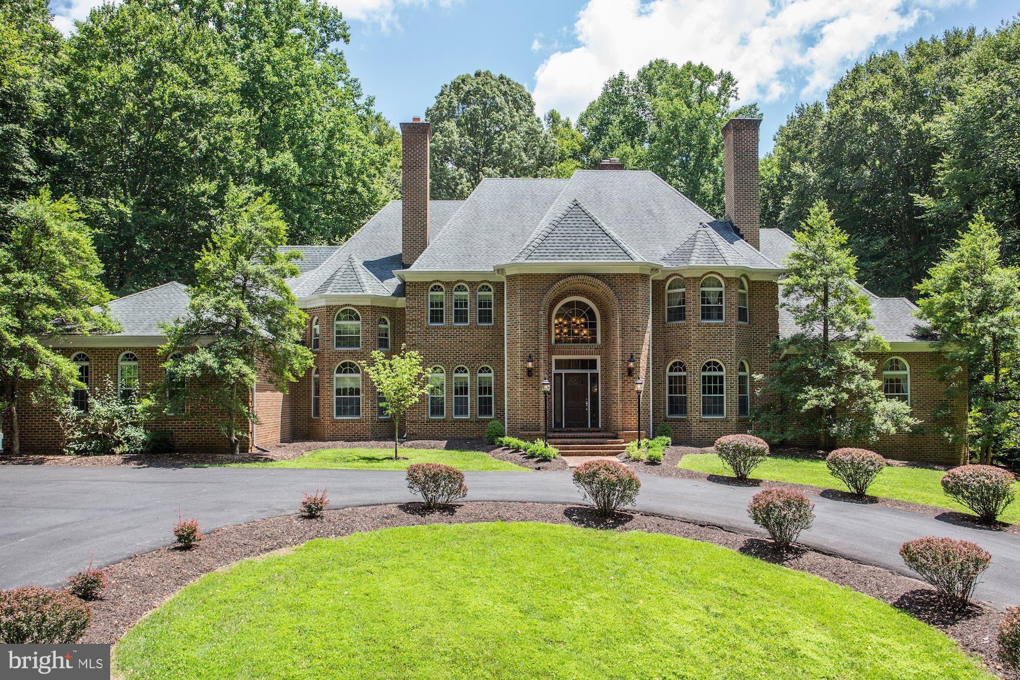 167 Yarnick Road is a remarkable and beautifully crafted Country Manor that echoes the influence of Georgian architecture and spans approximately 12,000 livable square feet.  Subtle elements of Tudor and Contemporary design are also laced throughout, resulting in a finely built and unique custom home. Behind a gated entrance, this property is exclusively nestled on 5 lush acres in Great Falls. The sprawling grounds embrace you with privacy and whisk you away to this storybook retreat. A home built for generations to come, this property is comprised of 5 Bedroom Suites, a Guest Suite, and 8.5 total Baths. With nearly every lifestyle in mind, the abundant footprint of this extraordinary residence offers something for everyone. There is a Gourmet Kitchen suitable for every caliber Chef, an easily accessible Main Bedroom Suite on the Main Level, an eye-catching Living Room with 19' ceilings and views of the Pool, and even a fully finished Lower Level outfitted for billiards, dance rehearsals, and game nights. The outdoor space is spectacular and features extensive hardscaping, a gorgeous pool, and areas for seating and dining. There is a semi-finished, side-loading 3-Car Garage and a Circular Driveway.
