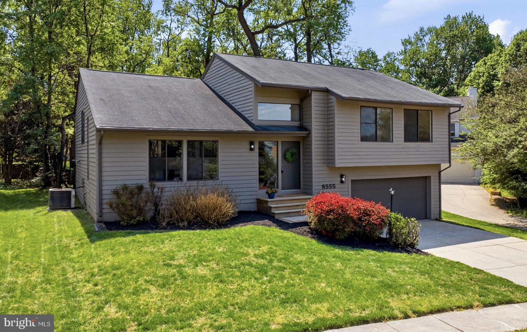 REQUESTING ALL OFFERS BY MONDAY AT NOON.  You’ll love living in the desirable Wheatfield community! This updated split-level contemporary home welcomes you with thoughtful design and an abundance of natural light streaming through clerestory and transom windows. Guests are greeted in a grand two-story foyer featuring a convenient, large coat closet before stepping into a bright living room highlighted by a soaring vaulted ceiling. Just upstairs on the main level, an elegant dining room overlooks the living area and flows seamlessly into a well-appointed kitchen. Perfect for entertaining, the kitchen offers space for a table, stainless steel appliances, and a bright skylight, all while framing beautiful views of the mature, tree-lined backyard. The kitchen opens directly into a cozy family room, creating the ideal space to unwind. From here, step through elegant French doors onto a newly renovated tiered deck (2026), complete with stairs leading down to your picturesque yard for outdoor grilling and relaxing. The main level also hosts three spacious bedrooms, headlined by a private owner’s suite. This relaxing retreat boasts a bright skylight and a luxurious ensuite bath equipped with a soaking tub, a separate tiled shower, and a dual-sink vanity with quartz countertops. An additional full bathroom comfortably serves the two secondary bedrooms. Head to the lower level to discover a wide-open, unfinished space offering endless potential to build out a large recreation room, home office, or additional bedroom, complete with a bathroom rough-in. This level also features a spacious laundry and mudroom located right off the two-car garage, the perfect drop zone to welcome the family home and store shoes, backpacks, and sports gear. Featuring fresh paint and brand-new carpet throughout (2026), this move-in-ready home offers a spacious driveway for ample parking and an unbeatable location just moments from Long Gate Shopping Center and major commuter routes like Route 100 and Route 29.