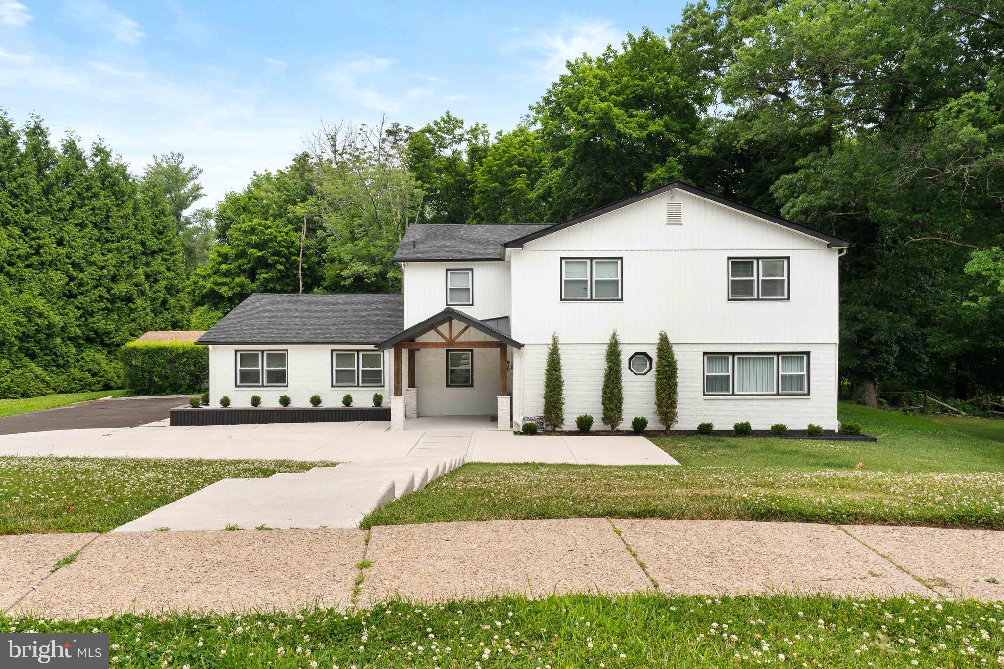Welcome to this beautifully remodeled and meticulously maintained home in the highly desirable Huntington Valley area, where modern elegance and exceptional craftsmanship come together to create a truly move-in ready residence.

From the moment you arrive, the home's impressive curb appeal is undeniable. A stunning custom concrete driveway leads to the attached two car garage, while the home's clean lines, manicured exterior, and contemporary updates set the tone for what awaits inside.

Step through the grand double entry doors into a spacious foyer accented by beautiful oversized tile flooring and an abundance of natural light. Just off the entrance, double doors open to a versatile office or flex space, perfect for working from home, a playroom, guest room, or potential fifth bedroom.

The heart of the home is the spectacular designer kitchen, thoughtfully renovated with both style and functionality in mind. Featuring premium Bertazzoni appliances, including a gas range and refrigerator, this culinary space is sure to impress. Quartz countertops, an expansive center island, abundant cabinetry, and sleek finishes create the perfect setting for everyday living and entertaining. The open concept layout seamlessly flows into the spacious dining area and inviting family room, where a modern electric fireplace with custom built-ins serves as a stunning focal point.

Sliding doors provide direct access to the private backyard retreat, complete with a beautiful concrete patio surrounded by peaceful landscaping, offering the perfect setting for outdoor dining, relaxation, and entertaining.

The finished lower level adds valuable living space and features durable epoxy flooring along with a plumbing rough-in, providing the opportunity to add a future bathroom if desired.

The second floor offers four generously sized bedrooms and two full bathrooms, all complemented by hardwood flooring throughout. The luxurious primary suite serves as a private sanctuary featuring recessed lighting, a spacious walk-in closet, and a beautifully renovated spa-inspired ensuite bathroom complete with a soaking tub, double vanity, designer tile flooring, and a stunning glass enclosed shower.

Three additional bedrooms offer ample space and hardwood flooring, while the beautifully updated hall bathroom showcases elegant tile finishes, a double vanity, and modern fixtures.

Completing the upper level is a spacious laundry room with built-in cabinetry and additional storage for maximum convenience.

Every detail of this exceptional home has been thoughtfully updated to offer today's buyers the perfect combination of luxury, comfort, and modern design.
