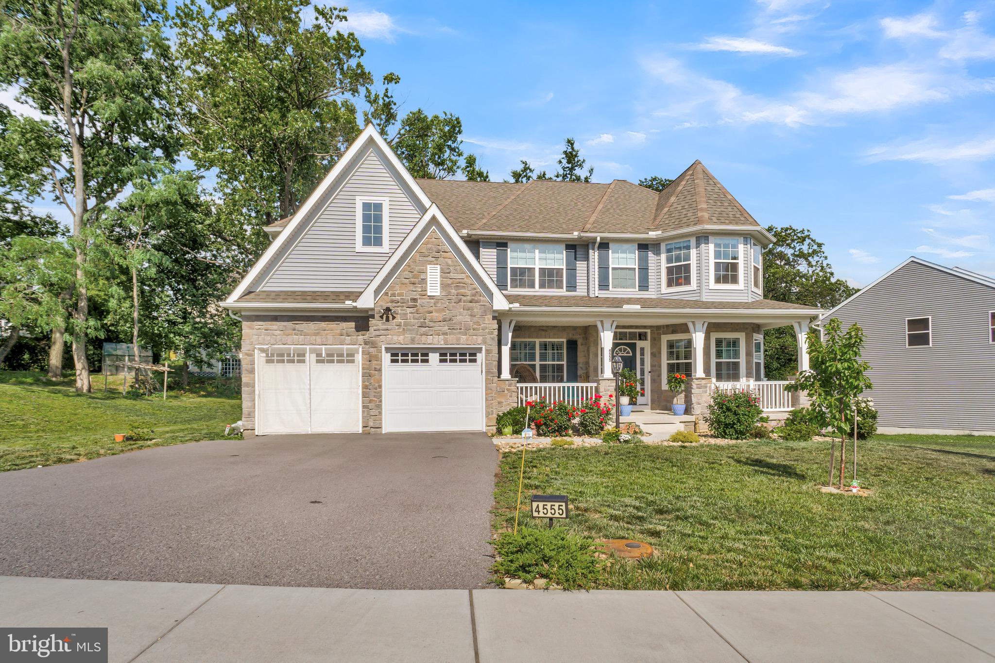 Welcome home! This house was built in 2023 and offers the perfect blend of modern style, comfort, and space. From the moment you arrive, you'll appreciate the inviting curb appeal with its stone-accented exterior, carriage-style garage doors, and welcoming presence. Step inside to a bright, open layout designed for both everyday living and entertaining. The heart of the home is the spacious kitchen, featuring quartz countertops, soft-close cabinetry, stainless steel appliances, a large center island, and a walk-in pantry. Just beyond, the sunroom fills with natural light and provides the perfect spot to enjoy your morning coffee while overlooking the backyard. Outdoor living is just as impressive. The recently added composite deck creates a wonderful space for cookouts, gatherings, or simply unwinding after a long day, all surrounded by mature landscaping that adds privacy and charm. A first-floor bedroom and full bath offer flexibility for guests, extended family, or a home office. Upstairs, you'll find four additional bedrooms, each with a walk-in closet, along with a spacious owner's suite featuring a spa-like bathroom with dual vanities, a soaking tub, and a separate shower. The unfinished basement provides plenty of storage today and endless possibilities for future living space tomorrow. Solar panels help keep utility costs manageable, and the convenient location puts shopping, dining, major highways, and everyday conveniences just minutes away. If you've been looking for a newer home with room to grow, thoughtful upgrades, and a layout that truly works for modern living, this one is worth seeing in person. It may just feel like home the moment you walk through the door.