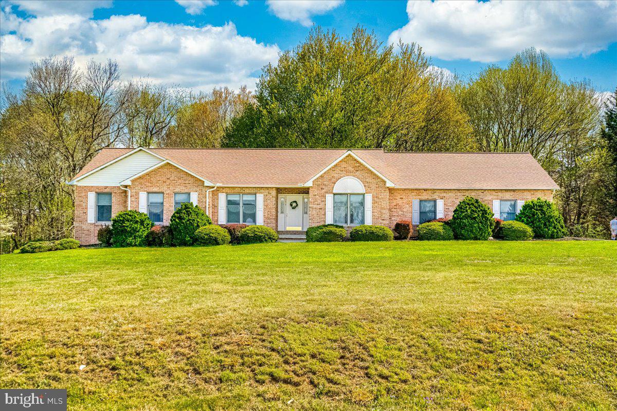 ** OFFERS RECEIVED. SELLER HAS REQUESTED AN OFFER DEADLINE OF MONDAY 5/4 AT 9AM **
Welcome to 1570 Wood Villa Drive! Nestled on 3 scenic acres with sweeping views of picturesque farmland. This inviting home offers the perfect blend of privacy and comfort. The spacious front yard and brick exterior create a warm and welcoming first impression.  Inside, you’ll find a bright and roomy foyer flanked by a formal living room and a separate dining room—ideal for both everyday living and entertaining. The well-appointed eat-in kitchen boasts granite countertops, stainless steel appliances, and ample cabinetry. Anyone who loves to cook will enjoy this space!  A charming bay window fills the eat-in area with natural light and views of the backyard.  Conveniently located just off the kitchen is a laundry room with additional pantry storage, access to the backyard, and a half bath, adding extra convenience to this home.  The expansive family room, which would serve as the heart of the home, is the place everyone will want to gather!  This room flows seamlessly into a beautiful sunroom—perfect for enjoying peaceful mornings or relaxing evenings while taking in panoramic views of the surrounding landscape.  This home offers two generously sized secondary bedrooms, both with hardwood floors and including one with a walk-in closet. The spacious primary suite features hardwood floors,  a walk-in closet, and an ensuite bath complete with a double vanity, walk-in shower, and soaking tub.
The partially finished basement provides endless possibilities for customization! Ideal for a recreation room, additional living space, or hobby area. There is abundant storage, a rough-in for a future half-bath, and a walkout to the backyard.  If you need extra space for projects, the large garage features a workshop area for the hobbyist!   Offering the ease of one-level living on a serene, private lot with stunning farmland views, this property is one you will want to see!  Schedule your private tour today!