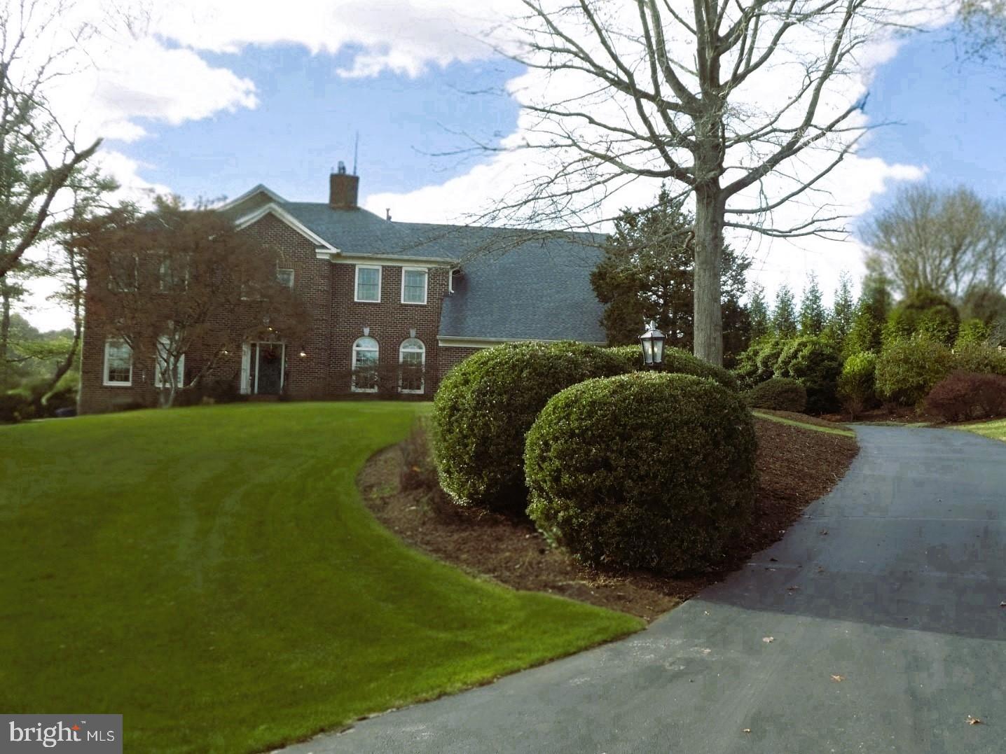 This classic brick colonial is sited on almost two acres in the Beach Mill Downs community and offers over 4,000 finished square feet on the upper two levels.   On the main level, the gourmet kitchen is a chef's dream, featuring high-end stainless-steel appliances, abundant cabinetry, and a large center island with counter seating. The kitchen opens to the main living area with a custom stone fireplace, creating a seamless flow for entertaining.   The upper level has a generous sun-drenched owner's suite with spacious bathroom, custom closet, and a sitting room.   There are also two additional large bedrooms with a shared bathroom and a guest room with private bath.  French doors from the main level open onto the deck and backyard which are an entertainer’s or garden lover’s dream.  The basement is a blank canvas – room for a living area, au-pair suite, home theater, workshop, fitness room, and storage.  The home's location on a quiet cul-de-sac offers a peaceful and private setting.
