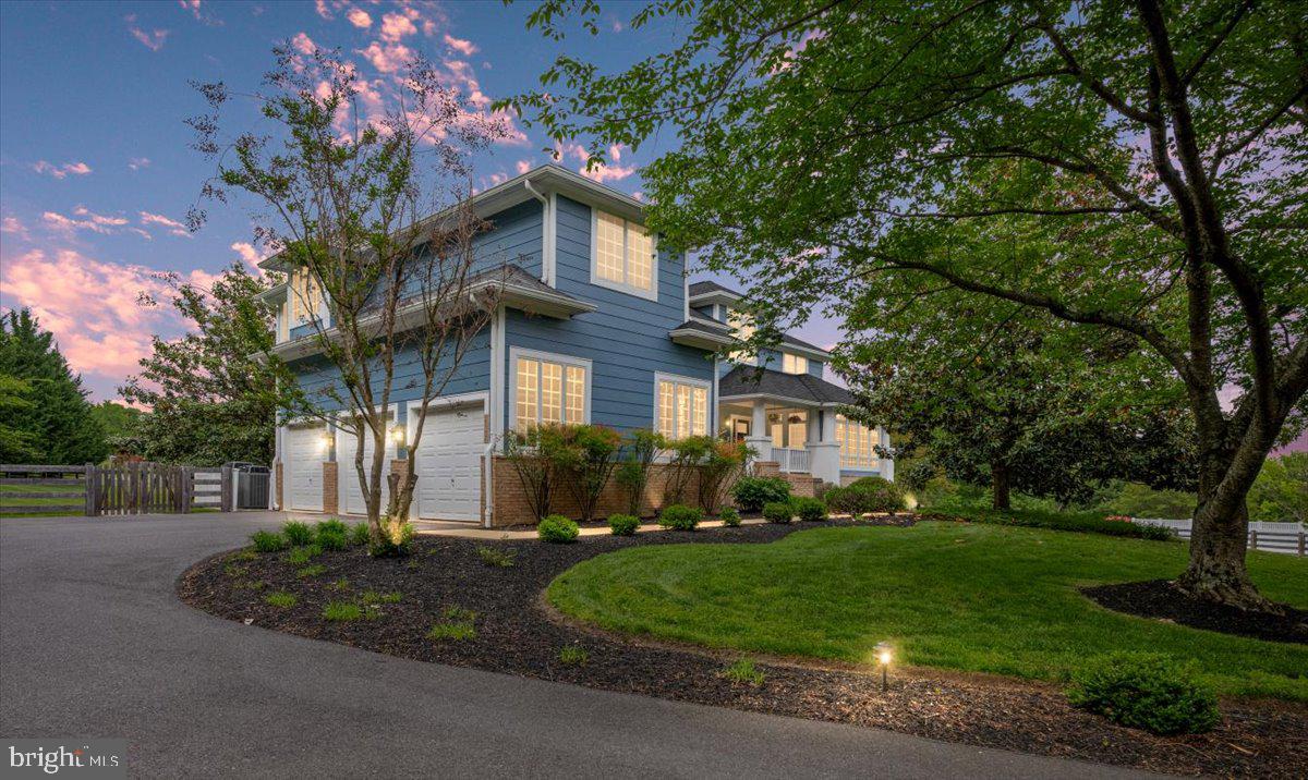 Welcome to your dream home in Glenelg Manor Estates! This one-of-a-kind, thoughtfully remodeled, Craftsman offers the perfect blend of character, comfort and modern convenience — all set on a stunning 4.15 acre lot in sought-after Howard County. With nearly 5,000 square feet above grade, and an additional 2,200 square feet in the finished walkout lower level, there’s room for everyone and everything. Upon arrival, you’ll notice meticulous attention to detail — from the Hardie Plank Siding and brick walkways, to the professionally landscaped lighted grounds featuring expansive pastoral views. Enjoy quiet mornings or relaxing summer evenings on the Trex-style deck, or stone-floored screened-in porch, both overlooking the custom heated 20x40' saltwater pool. The pool features wide custom steps, surrounded by elegant brick pavers and white vinyl fencing. A separate fenced-in area nearby is ideal for pets. Inside, this 5-bedroom 4.5-bath home is filled with charm and upscale touches. The welcoming foyer greets you with stained-glass windows, high ceilings and beautiful Craftsman railings. Hand-honed hickory floors run throughout much of the main level, adding warmth and timeless style. The heart of the home — the kitchen — has been fully remodeled with warm white cabinetry, soft-close drawers, natural quartzite counters, a walnut crowned center island and large walk-in pantry with custom built-ins. A high-end GE Monogram propane range and stainless-steel appliances complete the space. The breakfast area adjoins the screened-in porch, making indoor-outdoor entertaining seamless. Just off the kitchen, a practical mudroom with hooks and storage keeps everything organized. Stepping down into the family room you’ll encounter built-in shelving, a wood-burning fireplace and coffered ceilings — perfect for movie nights or cozy weekends. A private office with built-ins and a large closet, a sunroom flooded with natural light, a formal living room complete with propane fireplace, and a stylish powder room with ceramic flooring and black fixtures, completes the main level. Upstairs, the Primary Suite is a true retreat — spacious and serene with hand-honed hickory flooring, custom trim, casement windows, a large custom walk-in closet and a spa-like, remodeled primary bath, featuring a freestanding soaking tub, tiled shower stall and dual vanities. A private, second-ensuite bedroom includes a sliding glass door and Juliet balcony. Two additional bedrooms share a remodeled Jack-and-Jill bath, while a flex space is perfect as a playroom, study, or additional bedroom. Rounding out the 2nd level, currently serving as a craft area with stainless-steel wash basin, this room is plumbed and ready for a second washer and dryer, if desired. The expansive walkout lower level offers a haven for recreation, hobbies and entertainment, complete with built-ins, a large open area for games, and plumbing for a future bar or kitchenette. This level also features a dedicated workout room, an activity room, utility space and laundry area, two AO Smith propane water heaters, water treatment and radon mitigation systems, a dual zone propane heating system and two electrical subpanels. Storage abounds throughout, with large walk-in closets and custom built-ins. Additional highlights include multiple ceiling fans, built-in speakers, a 2nd/rear staircase to the kitchen and custom window treatments, featuring plantation shutters and shades. This extraordinary home seamlessly blends classic Craftsman charm with thoughtful, modern updates — all in a peaceful, picturesque setting. Whether you're hosting gatherings, enjoying quiet moments by the pool, or simply soaking in the serene views, every detail has been designed for your comfort and livability. Truly move-in ready and rich with character, this is a rare opportunity to own a standout property— a home you don’t want to miss!